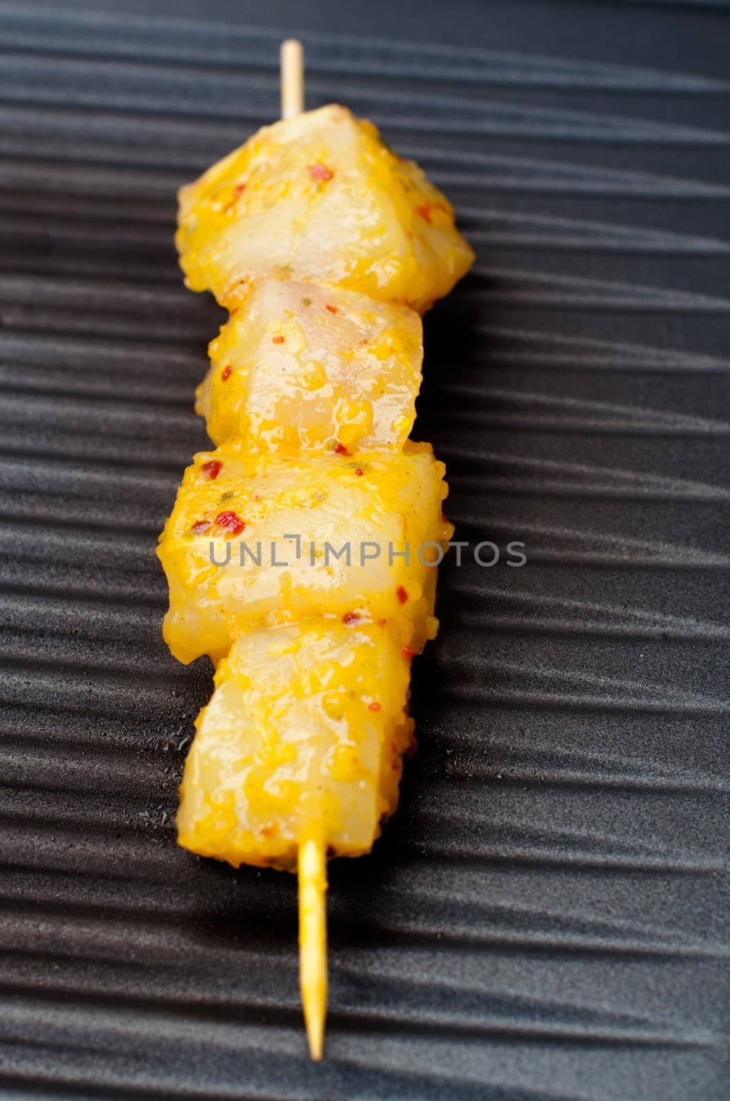 delicious fresh fish spear grilling on barbecue