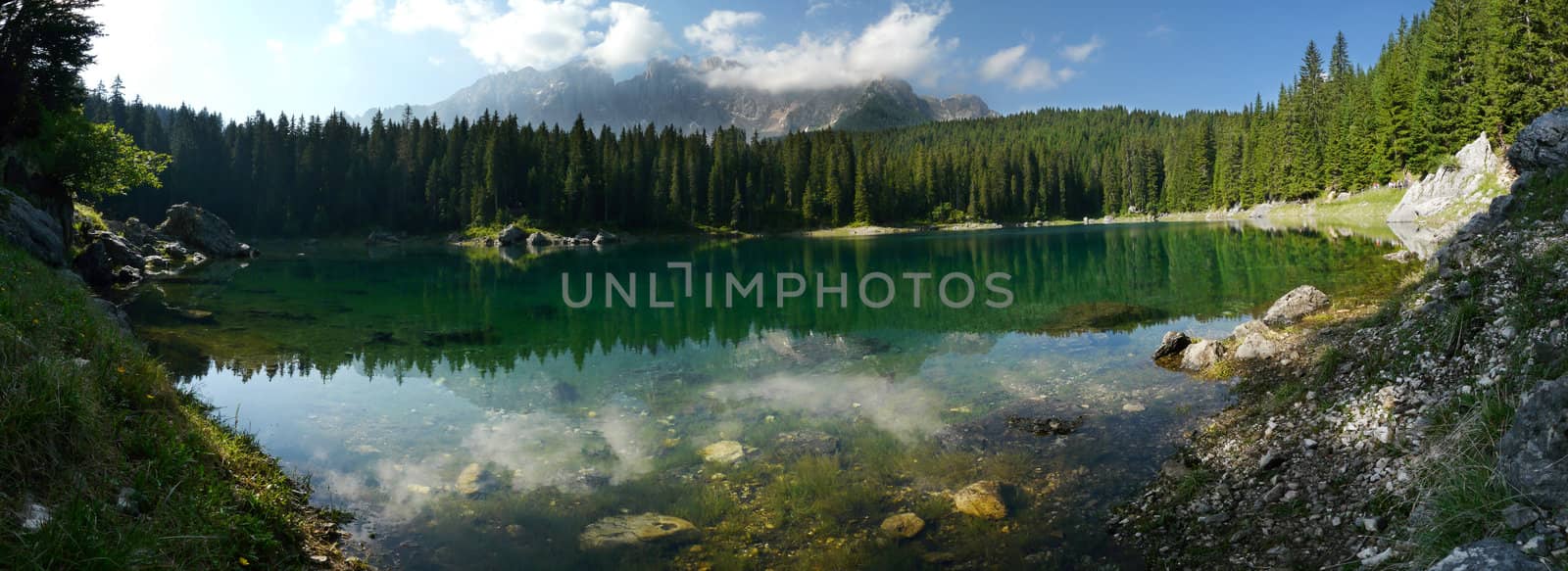Reflection of the Latemar in the incredibly clear blue Carezza Lake in the Italian Dolomites