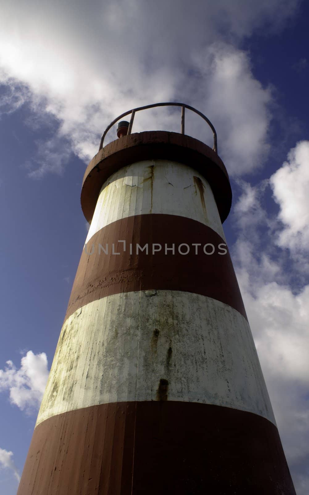 Lighthouse with a cloudy sky on the background
