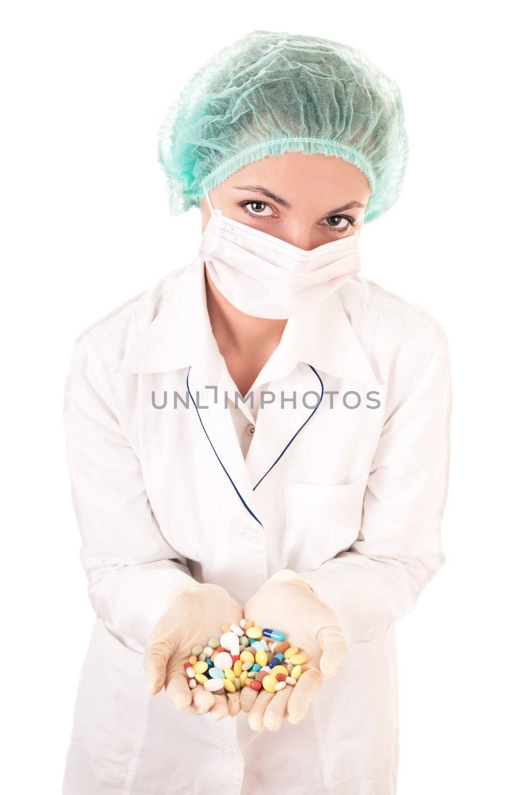 Serious doctor with pills in hands isolated on white background