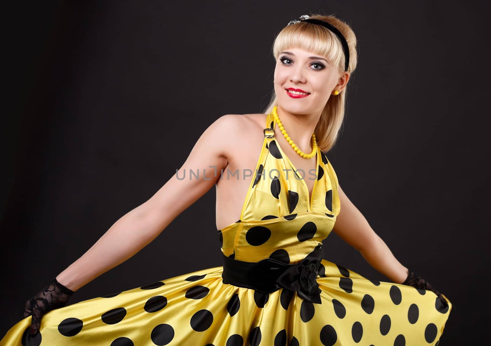 Young dancer woman in yellow dress.