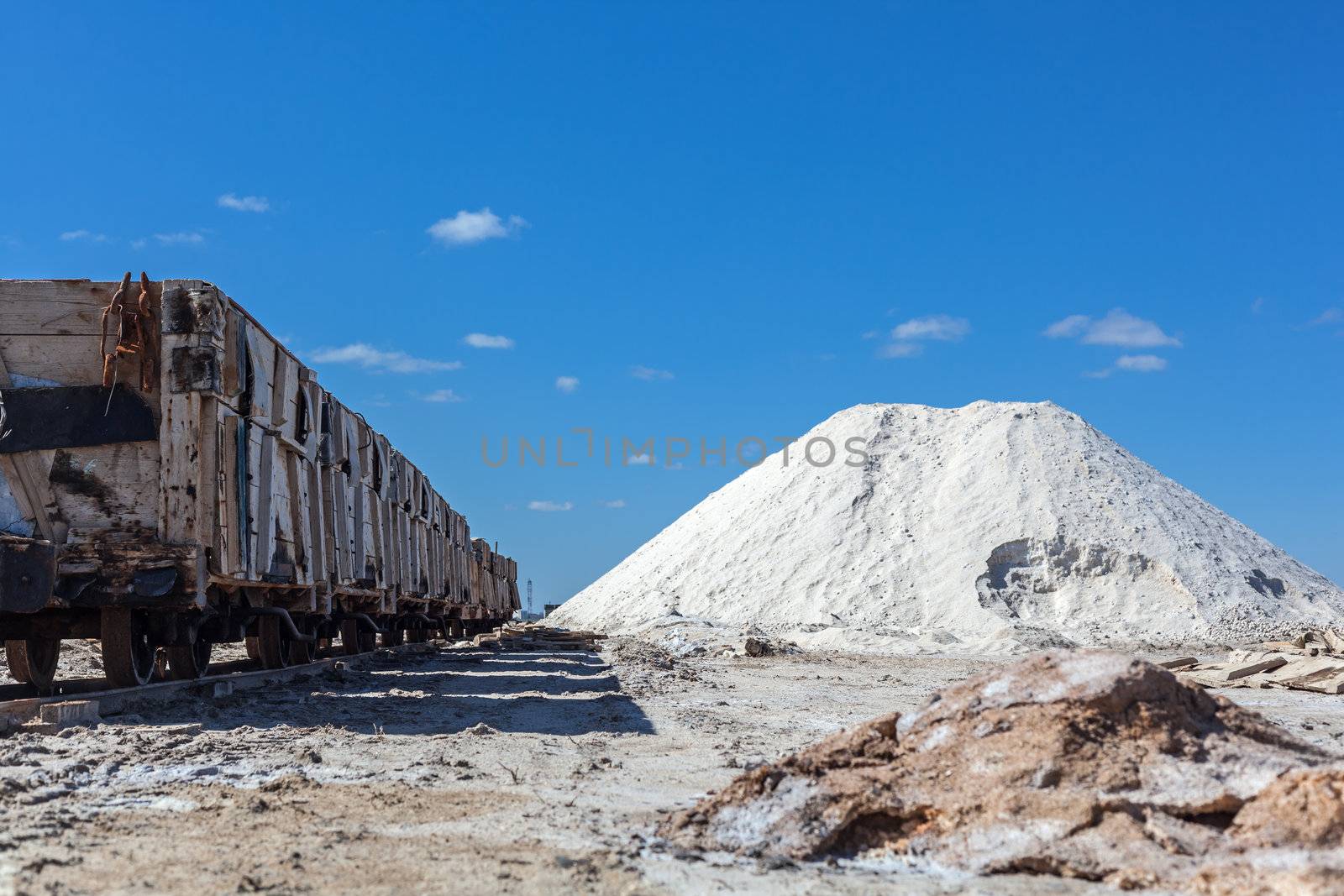 Big pile of freshly mined salt, set against a blue sky