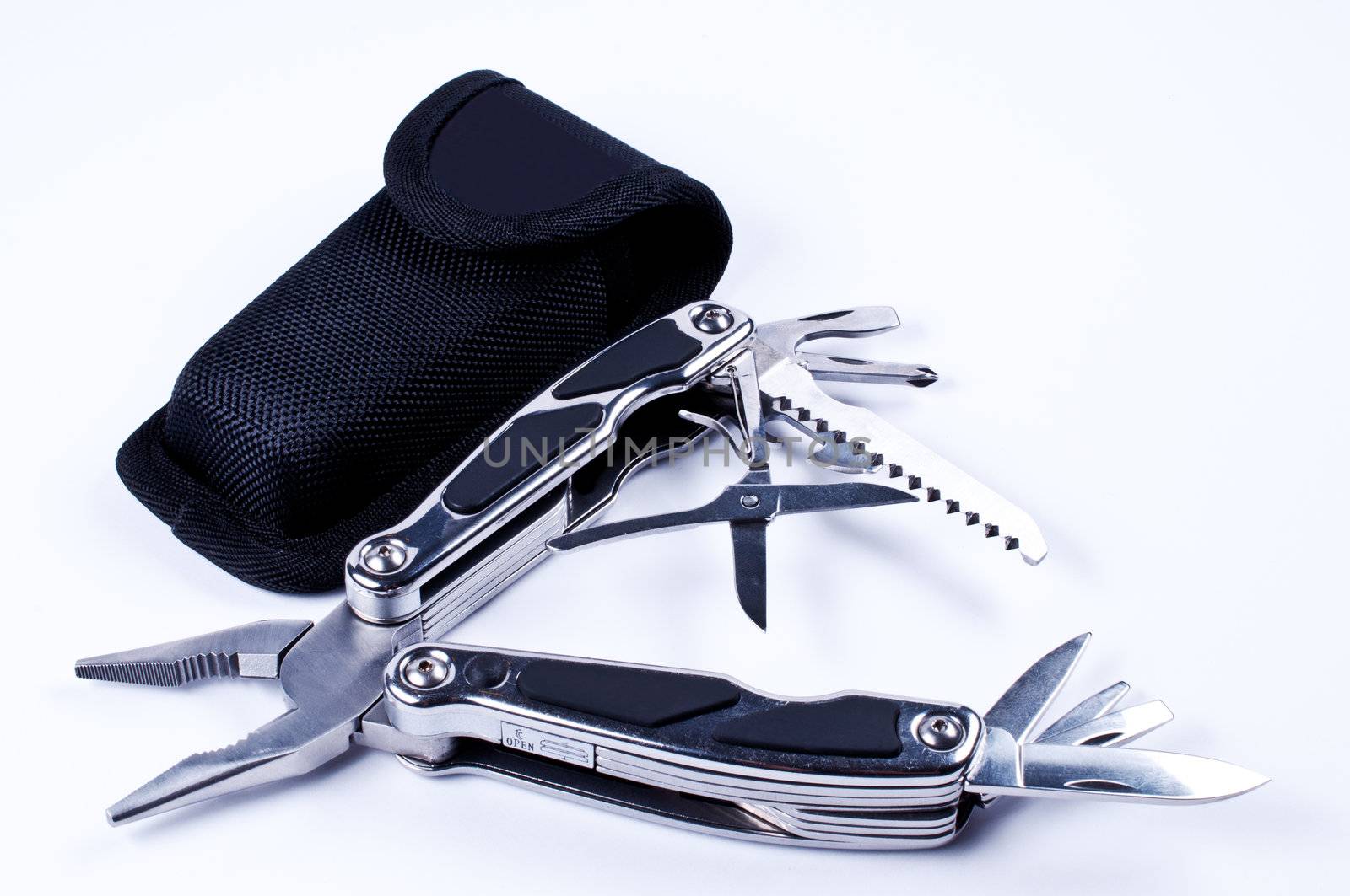 Fully unfolded multi tool with case on white background