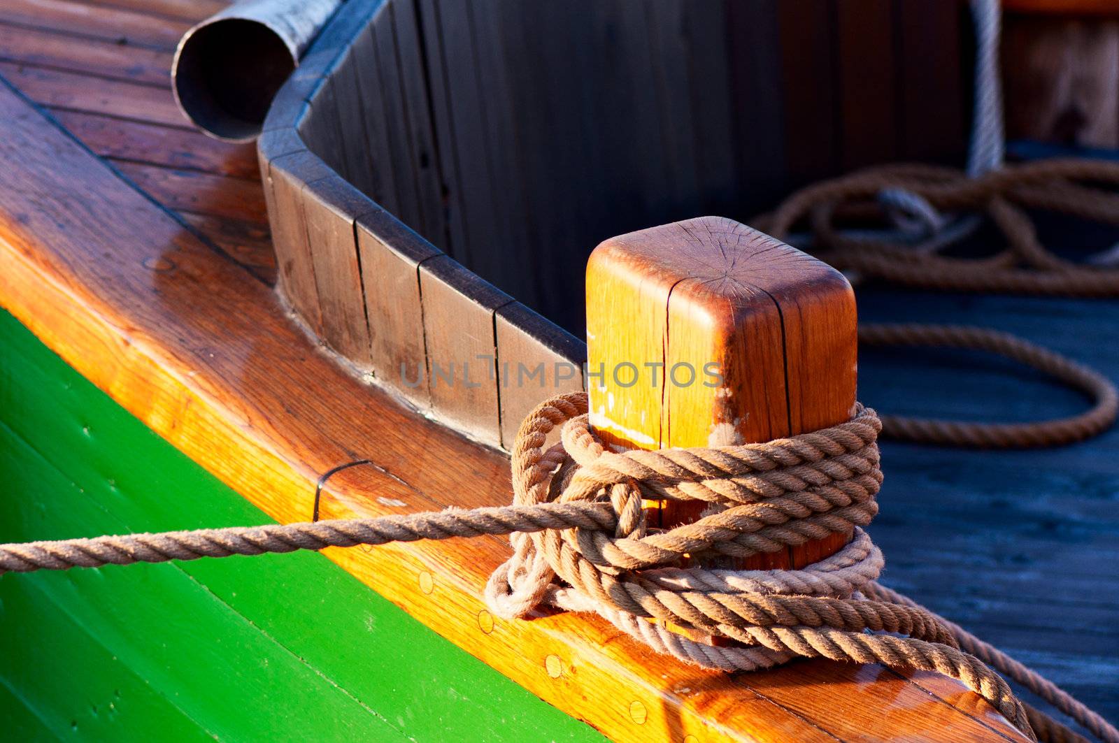 Close up of wooden bitt with rope