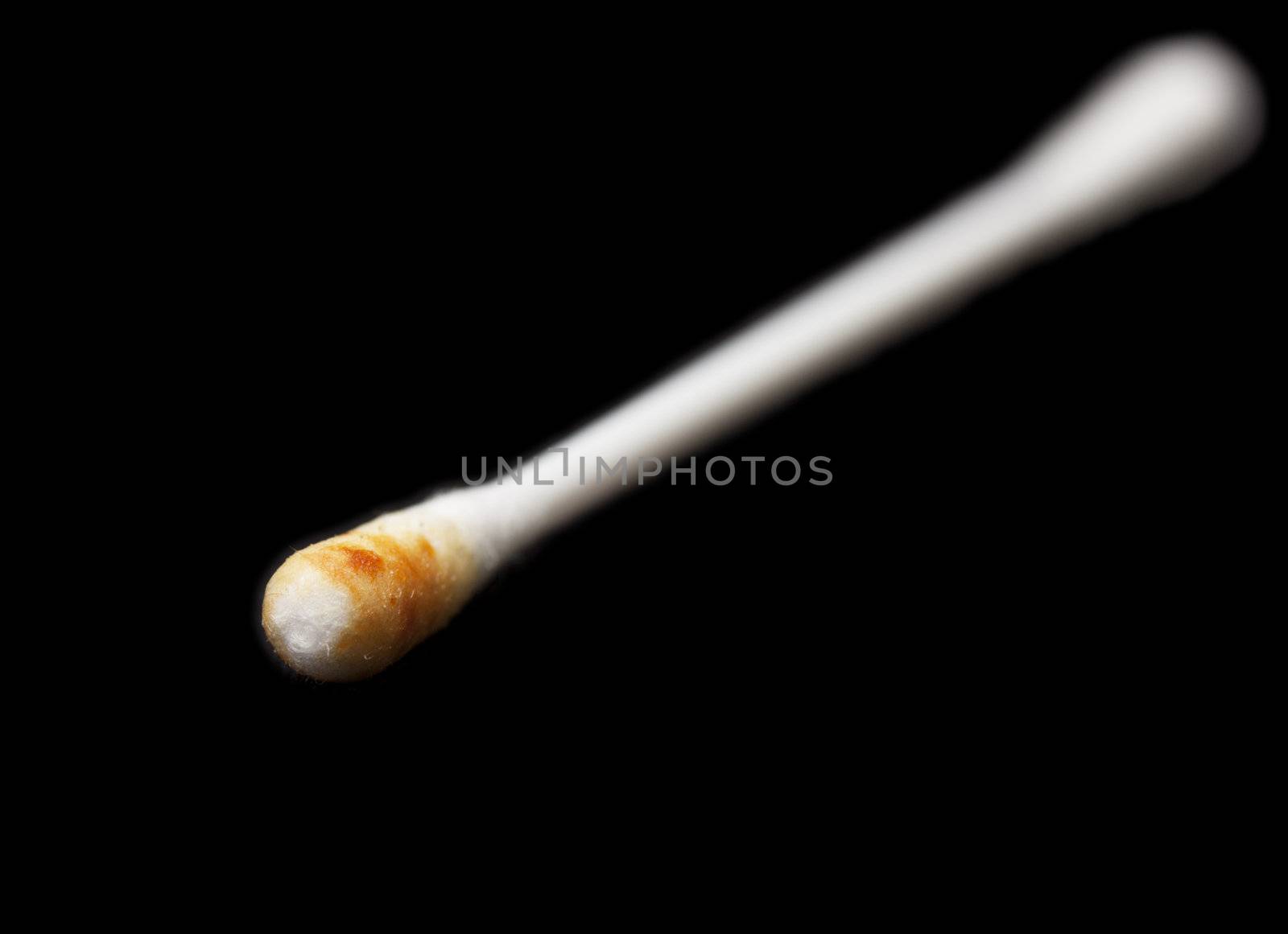 dirty ear stick on a black background. close