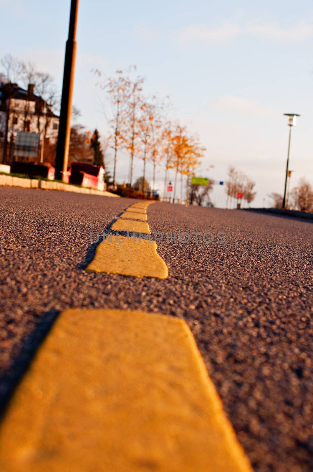 Yellow dividing line on asphalt road