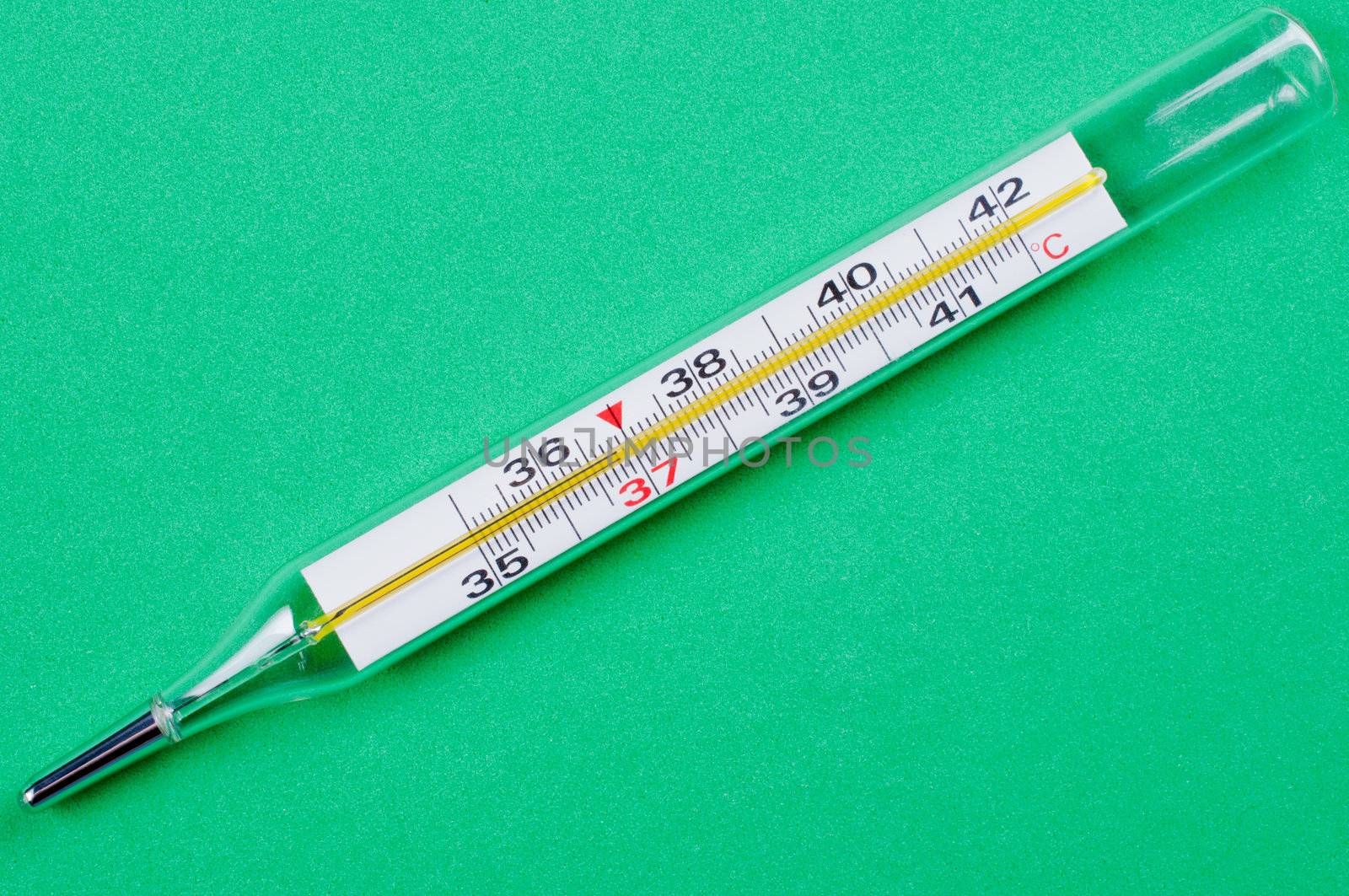 Thermometer close up  green background