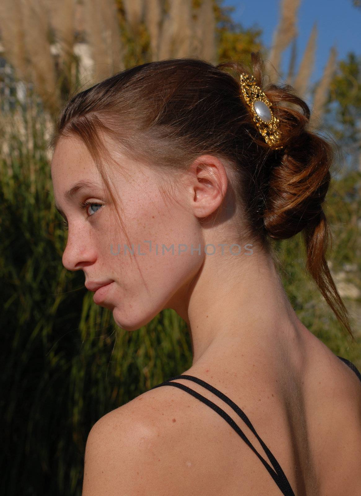 young woman and her beautiful hairstyle for ceremony