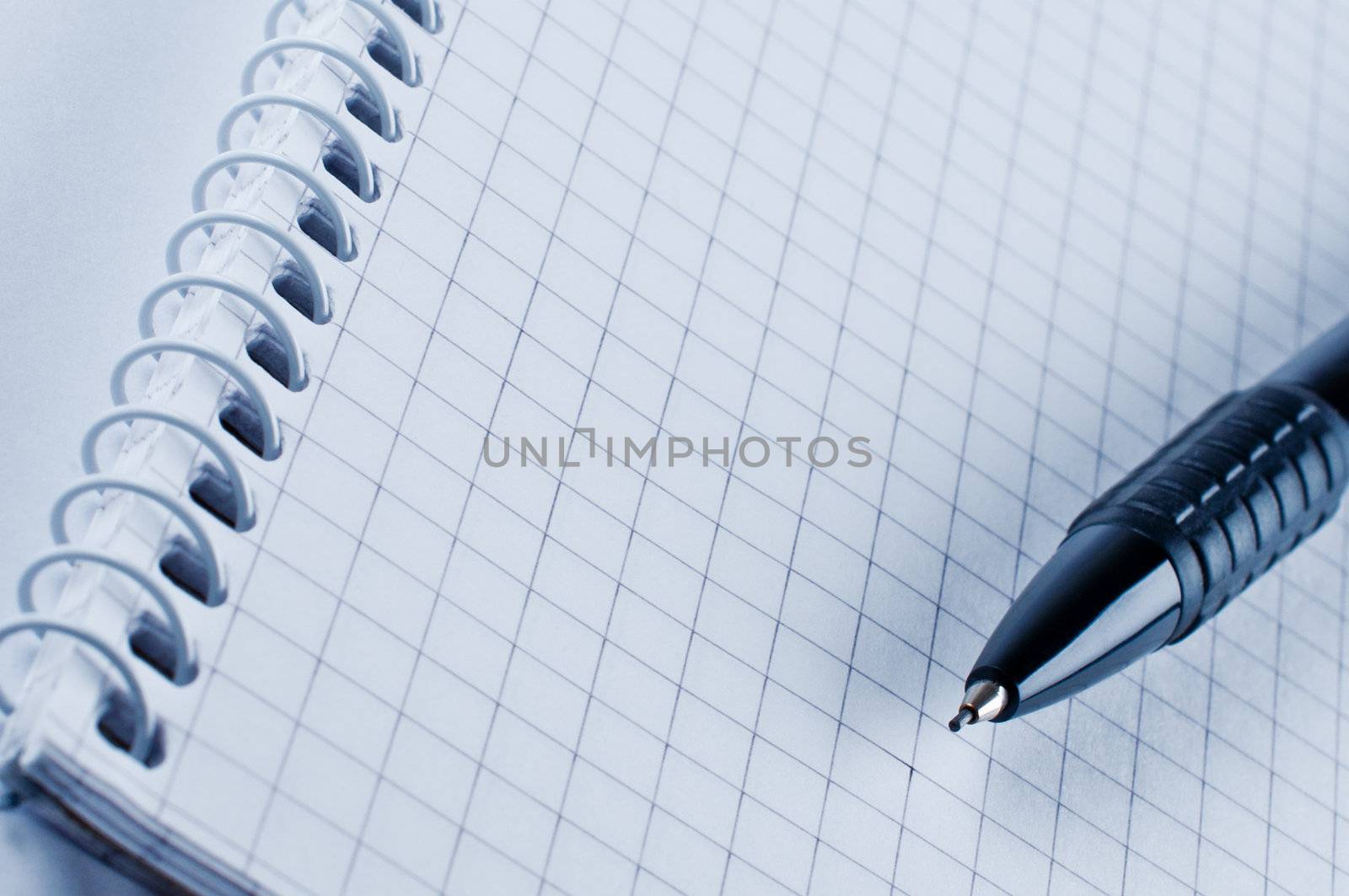 Black pencil on open white paper notebook