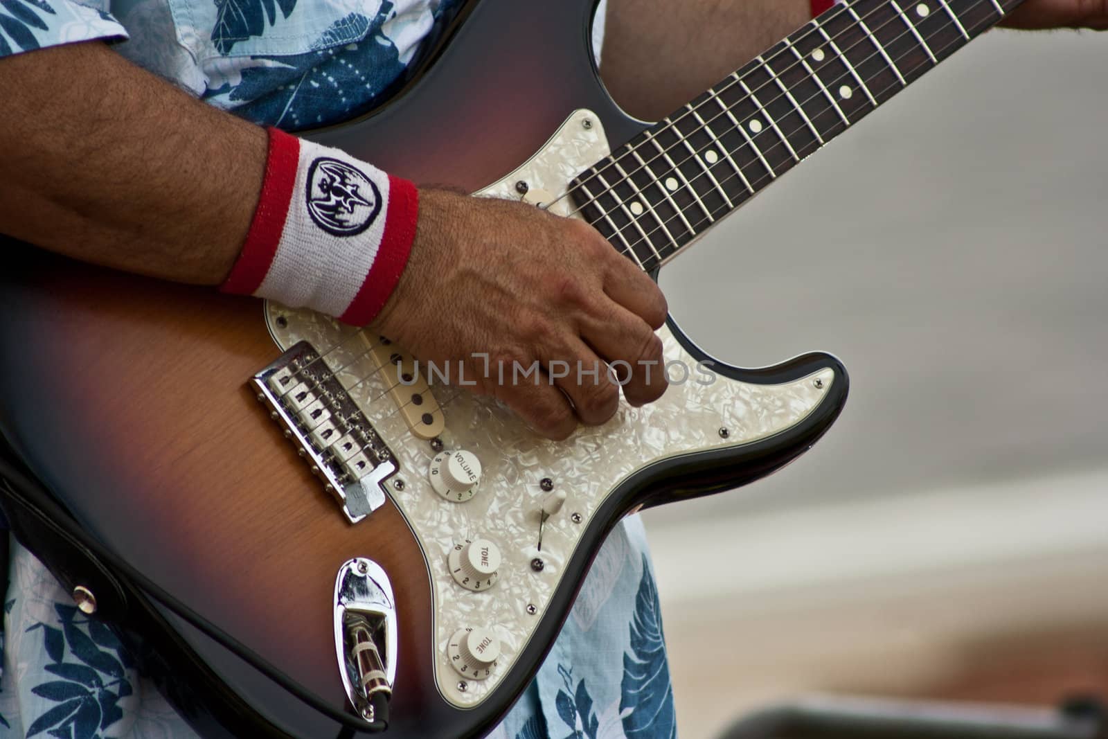 Six string guitar been played by unknow musician.