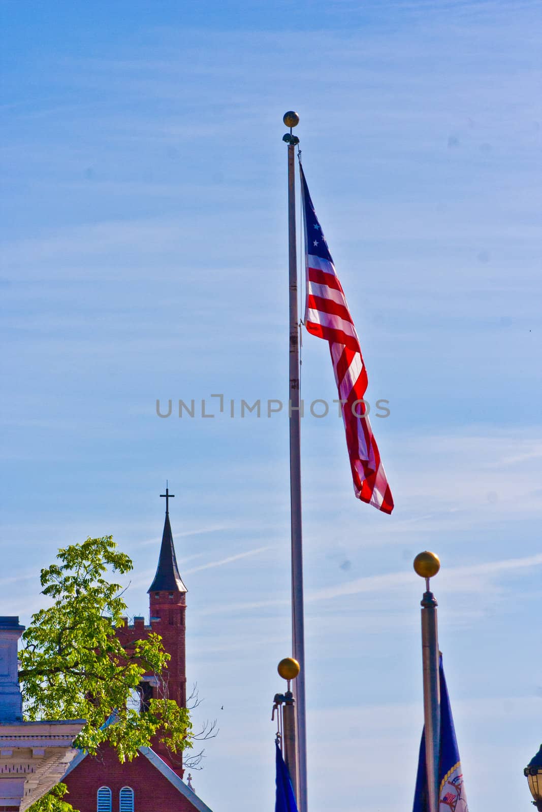 A single American flag stands high amongst church steeples.