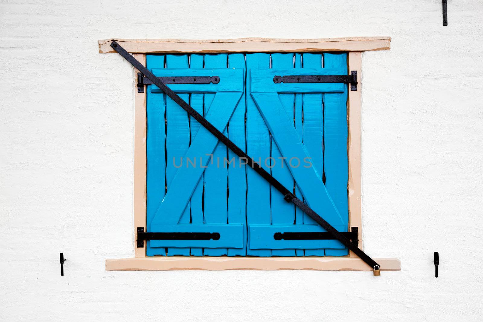 Old retro window with shutters on white painted house. Netherlands