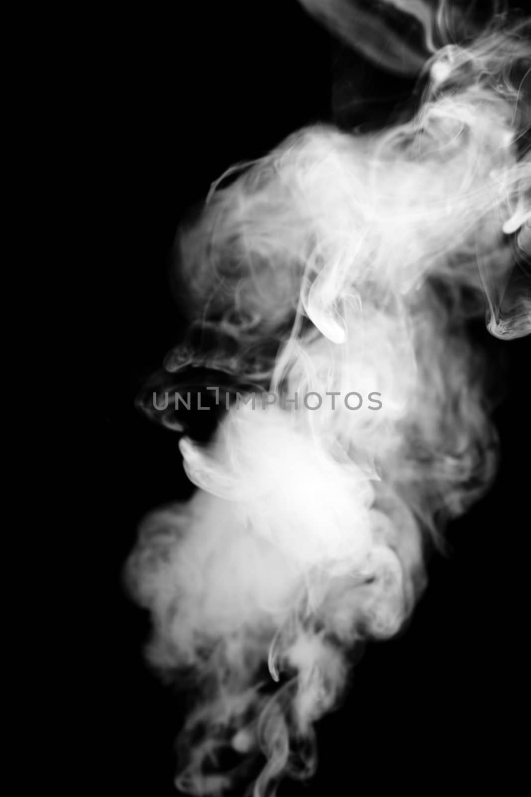 A photograph of real smoke on a black background. 