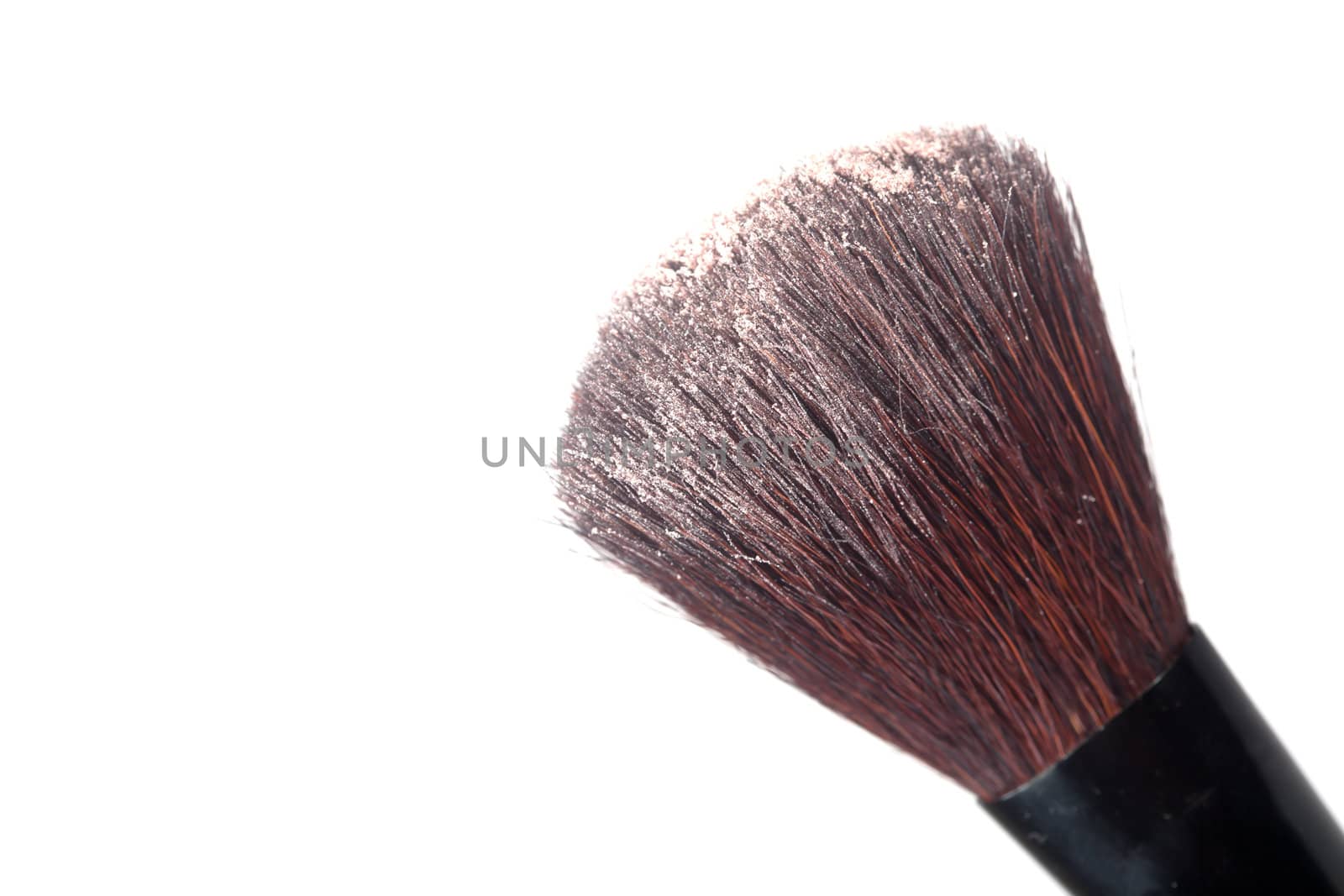 A blush brush with powder isolated on a white background.