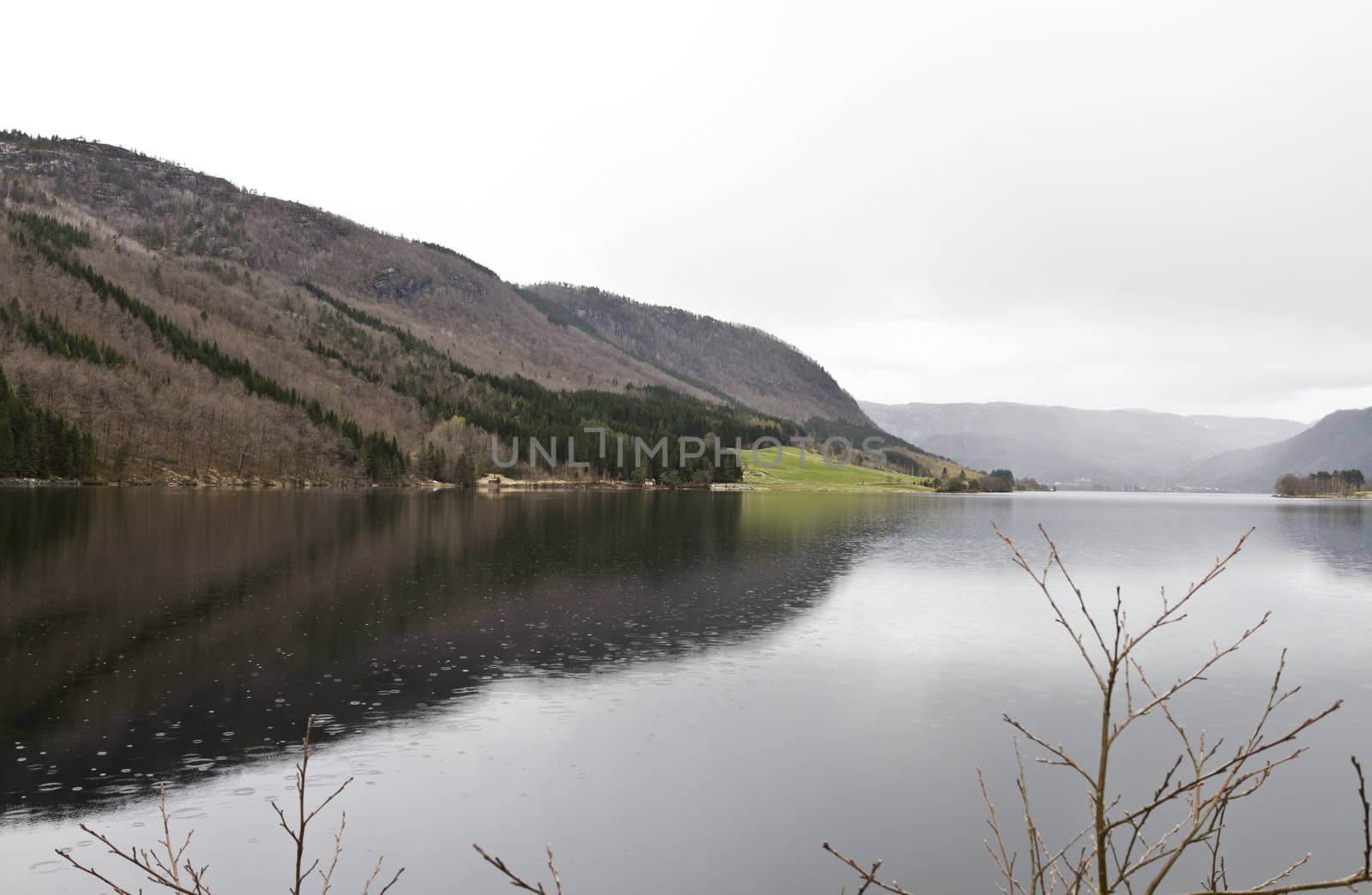 fjord in norway with raindrops falling in water