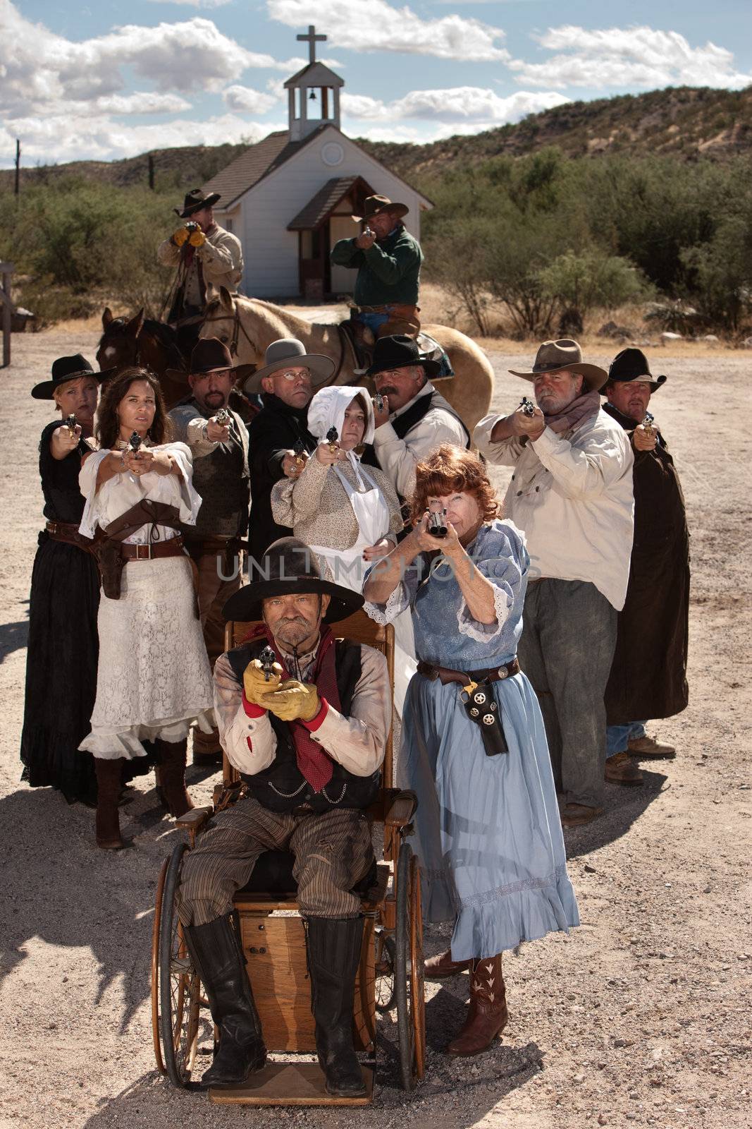 People in American old west scene with weapons in front of church