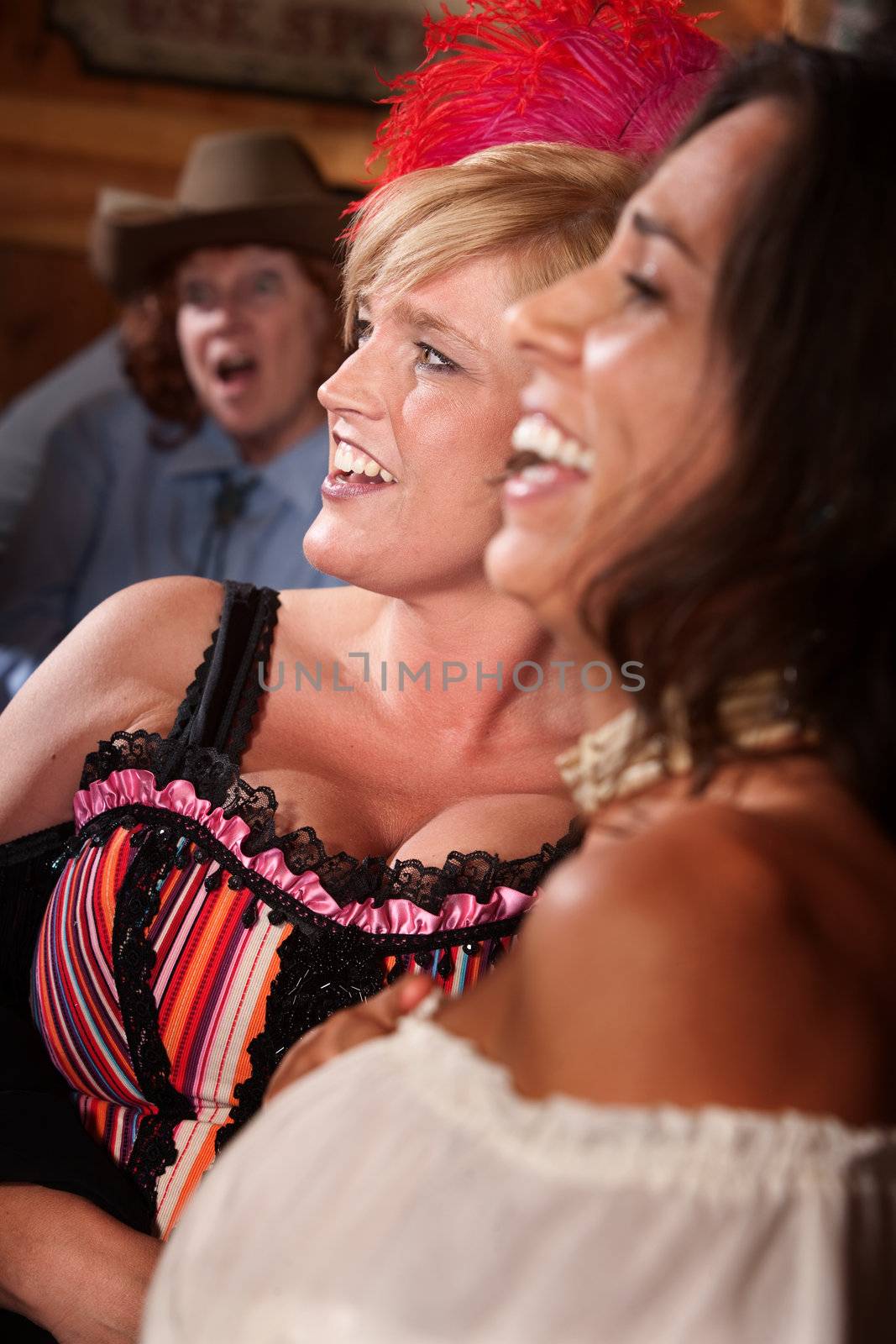Three happy women laughing in a saloon