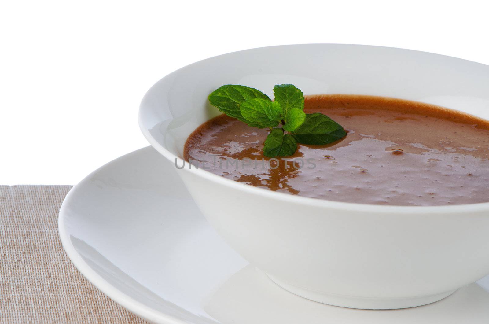 Chocolate mousse ou a white mug with mint leaves.