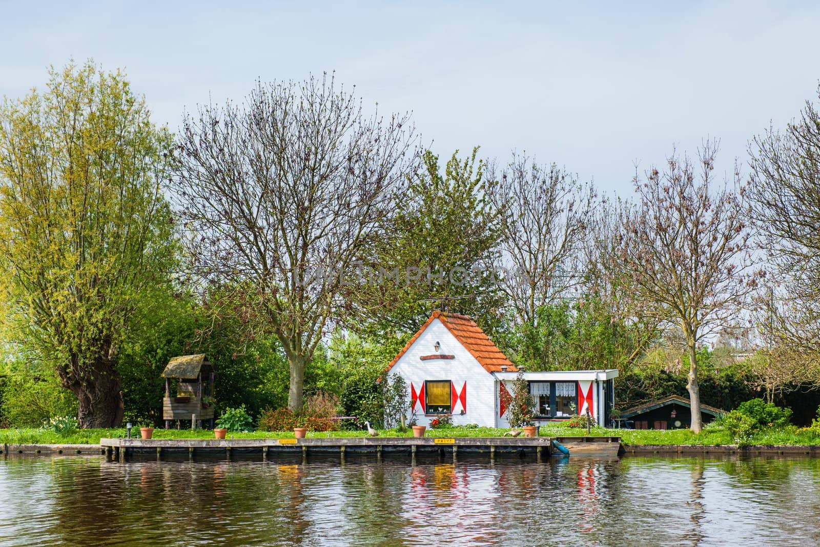 Typical spring holland landscape - dutch house near channel