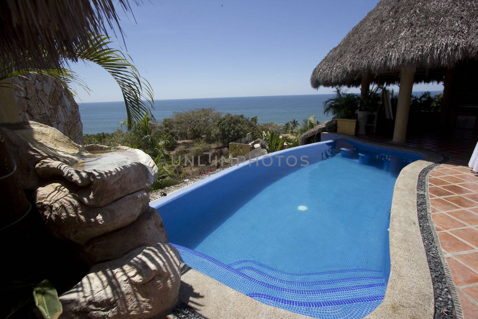 Mexican villa with beach view and a swimming pool.