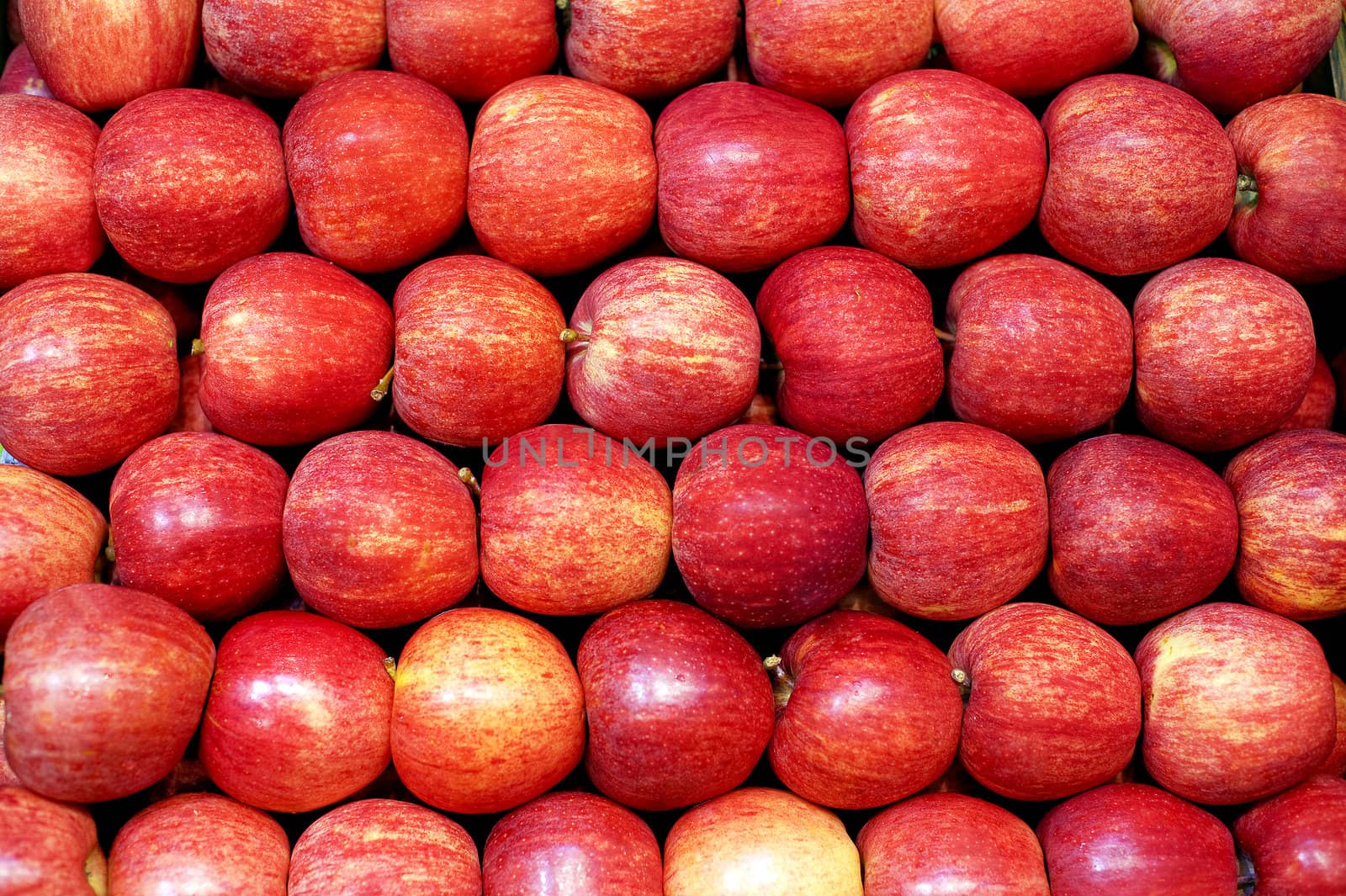 Apples neatly stacked in rows on farm stand