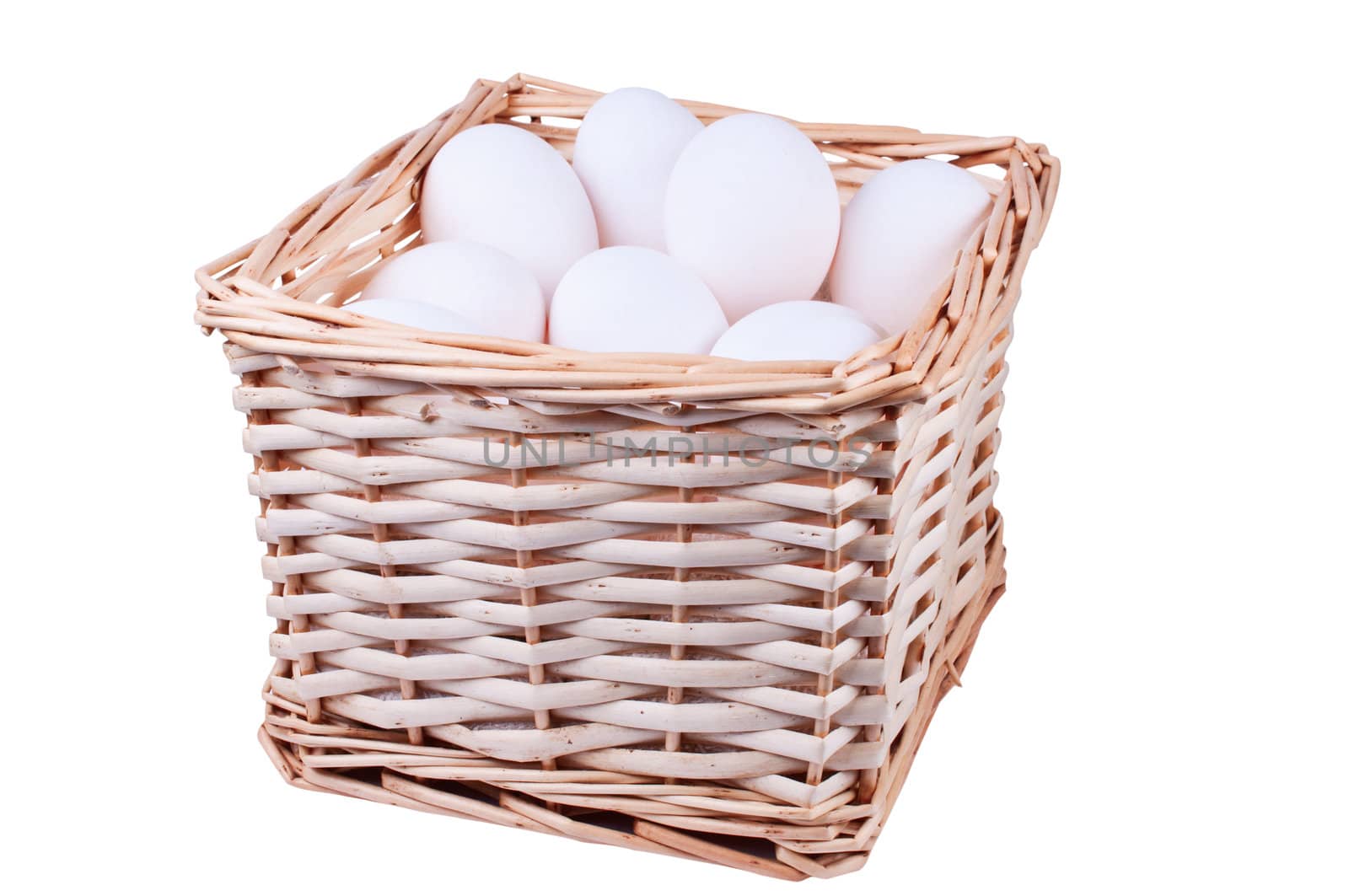 Wicker basket full of  chicken eggs isolated