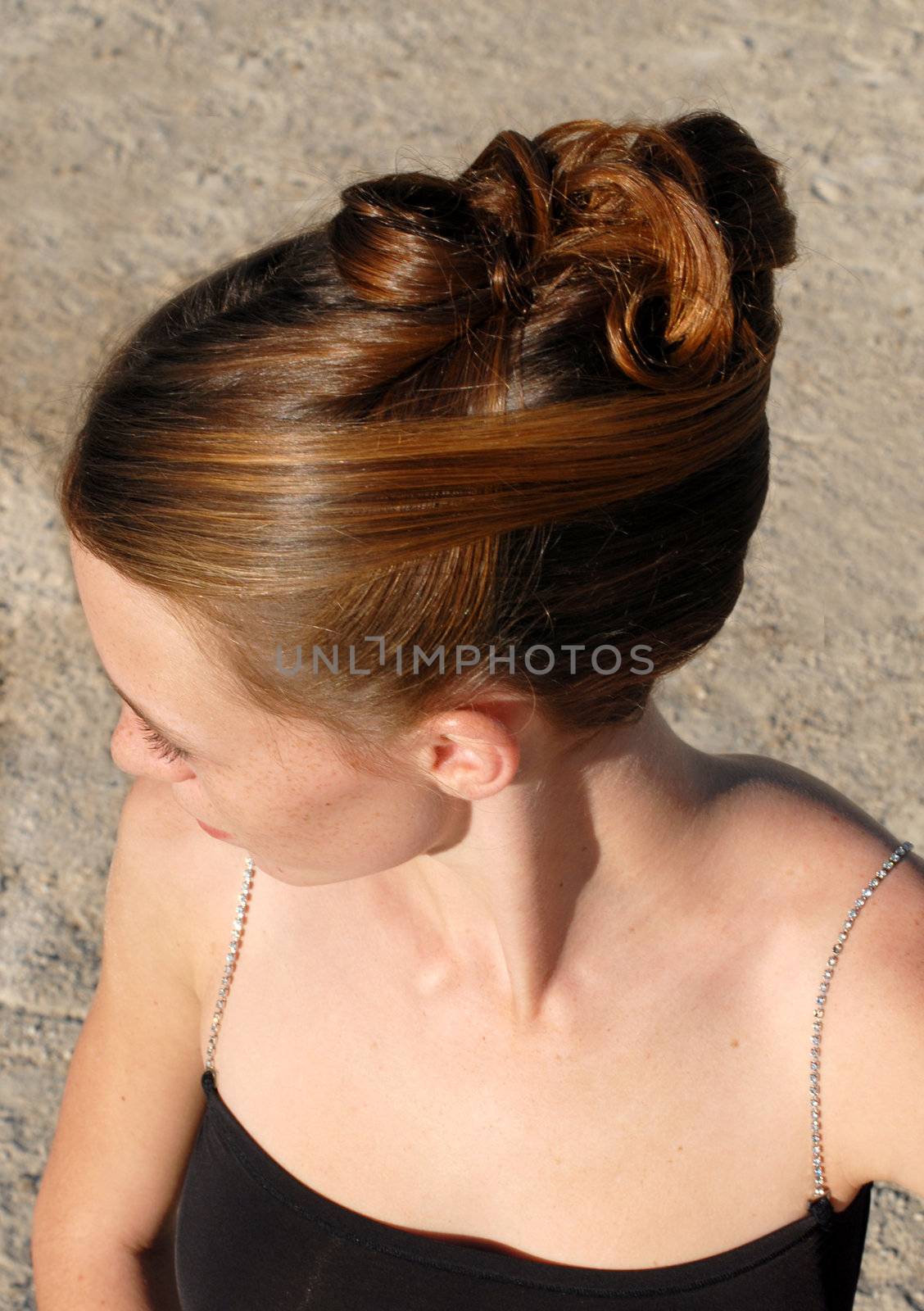 young woman and her beautiful hairstyle for ceremony 