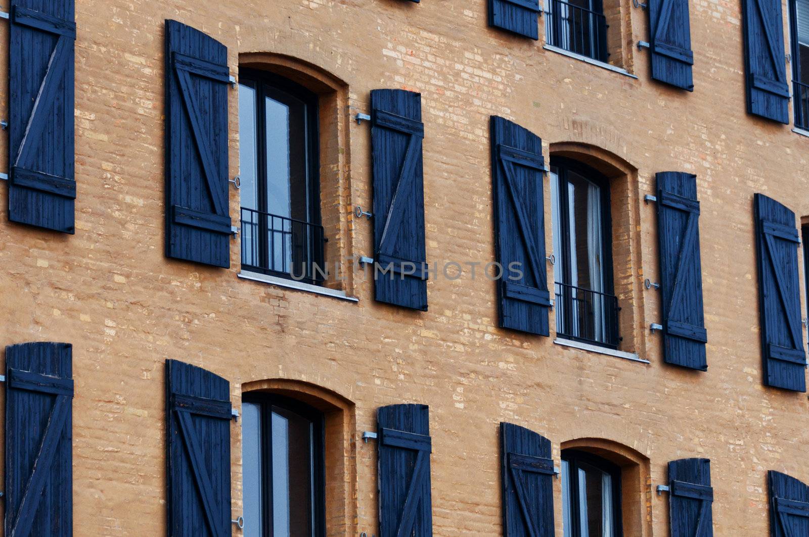 Old building with windows in a row by Nanisimova