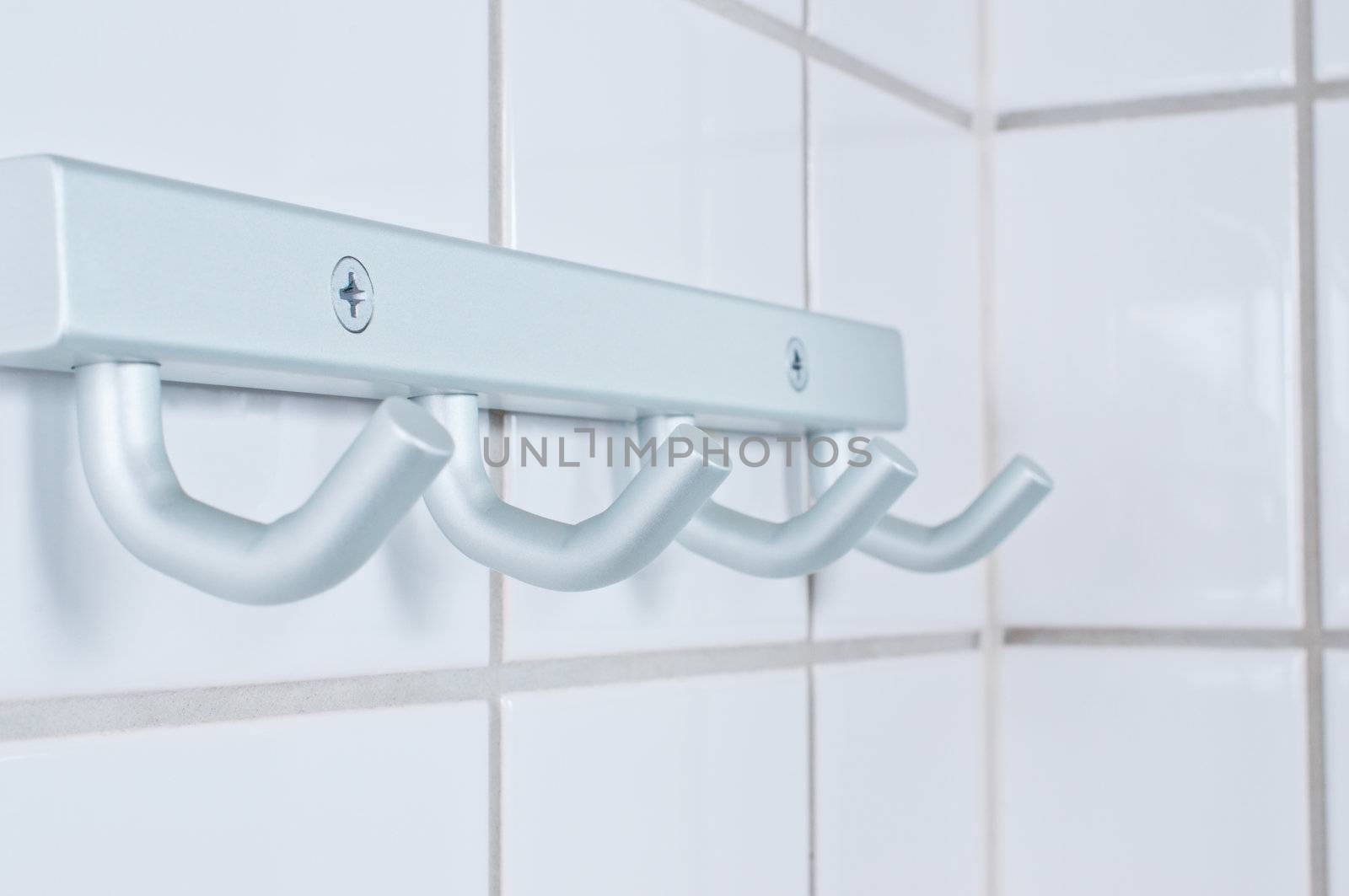 Brushed metal silver towel hanger on rest room wall