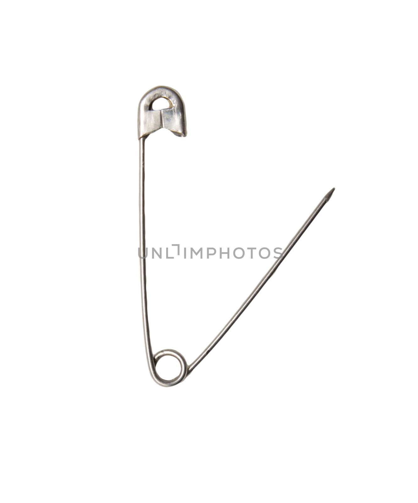 Closed safety pin. Cut out, on white background. Macro. On edge 