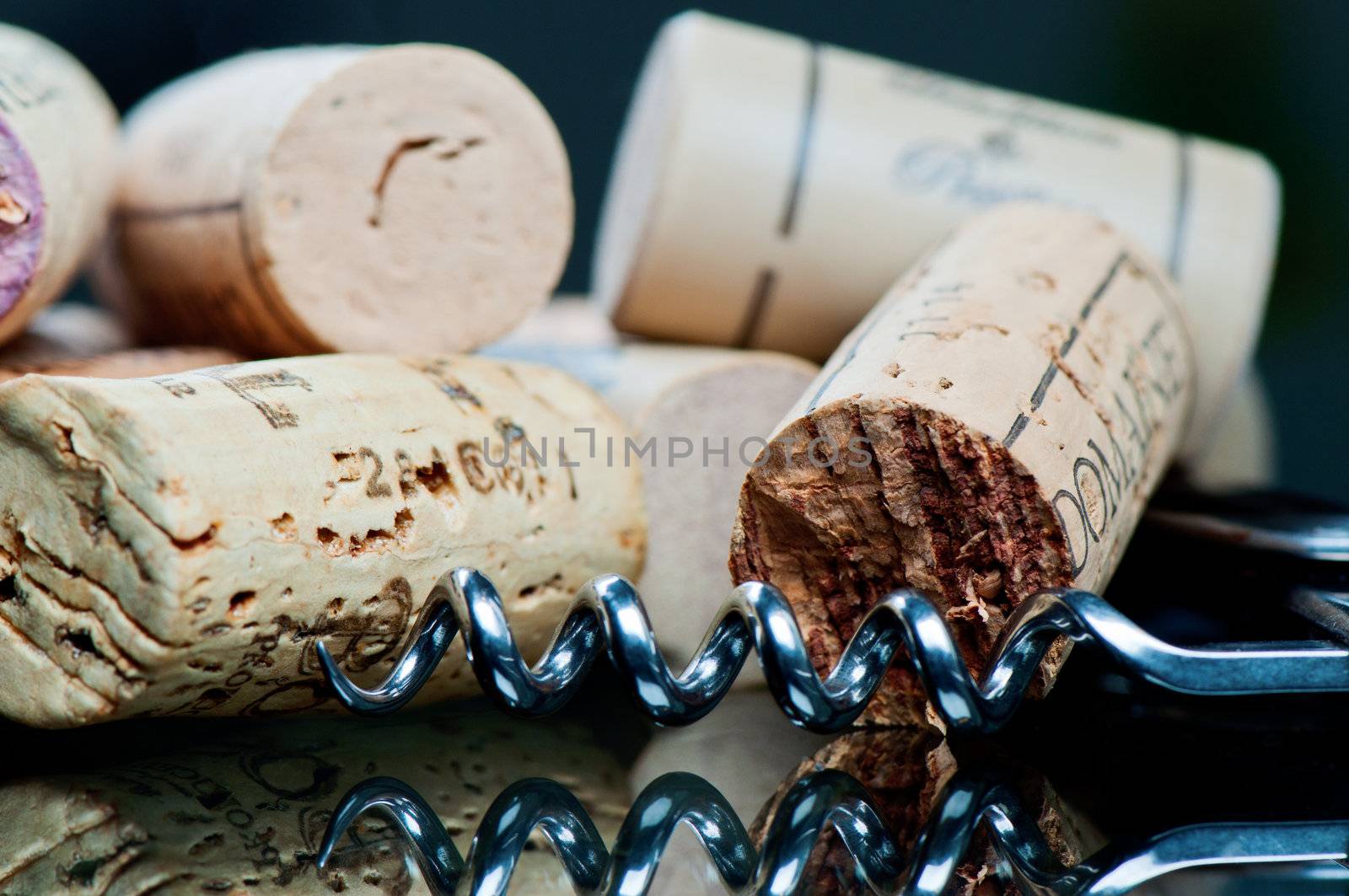 Corkscrew and corks on a glass table  by Nanisimova