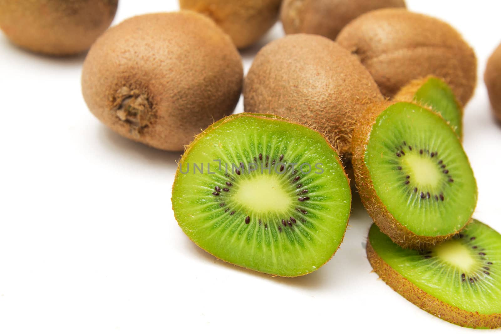 sliced and whole kiwi isolated on white background  by schankz