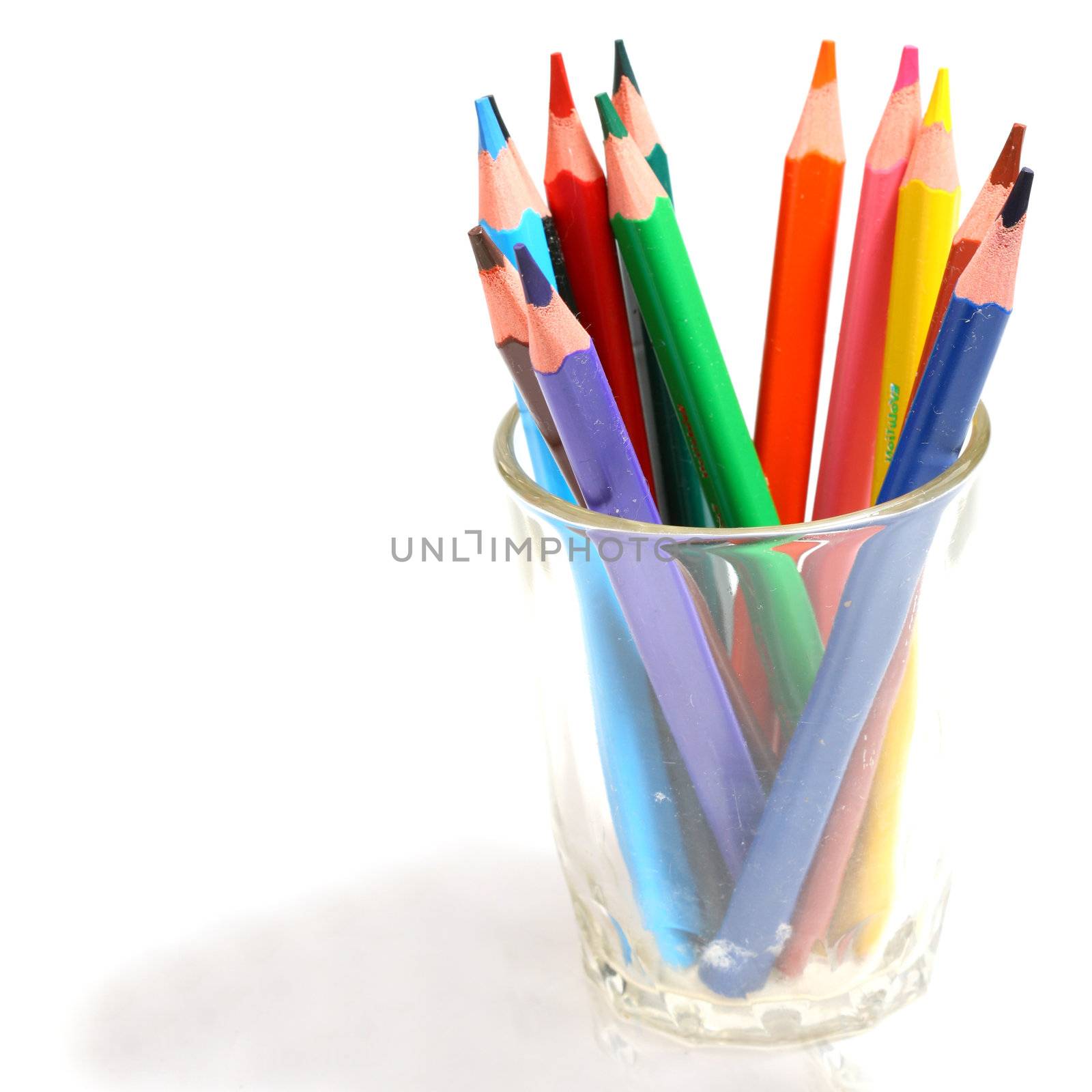 color pencil in glass macro close up on white
