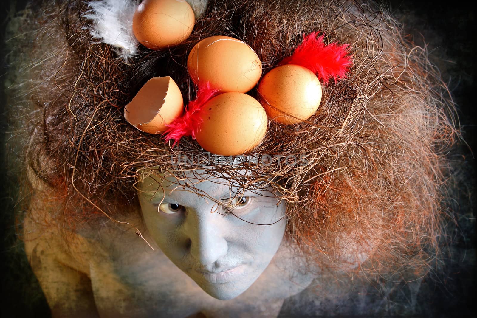 Woman with a painted face and a nest in hair