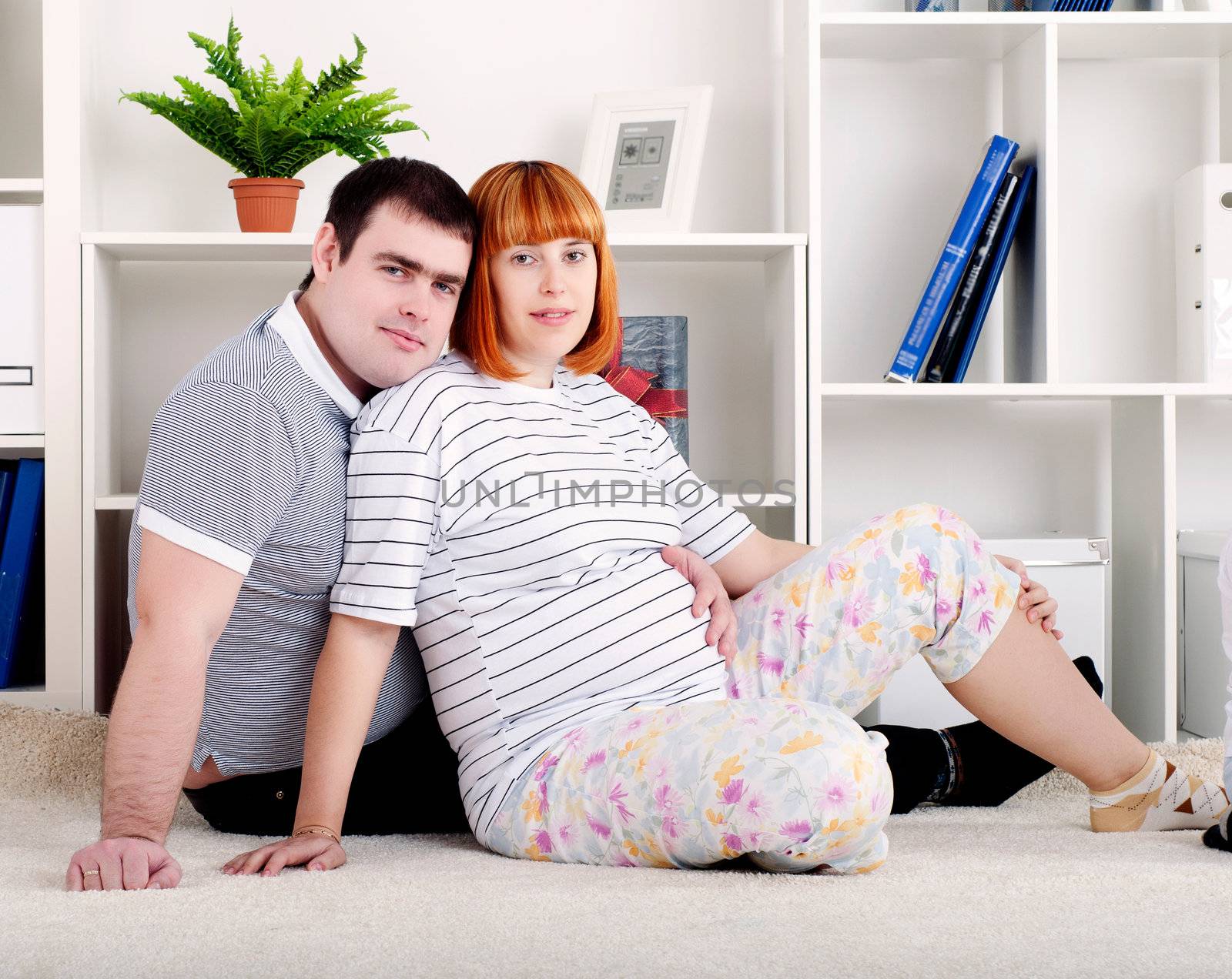 portrait of a pregnant woman and man, at home
