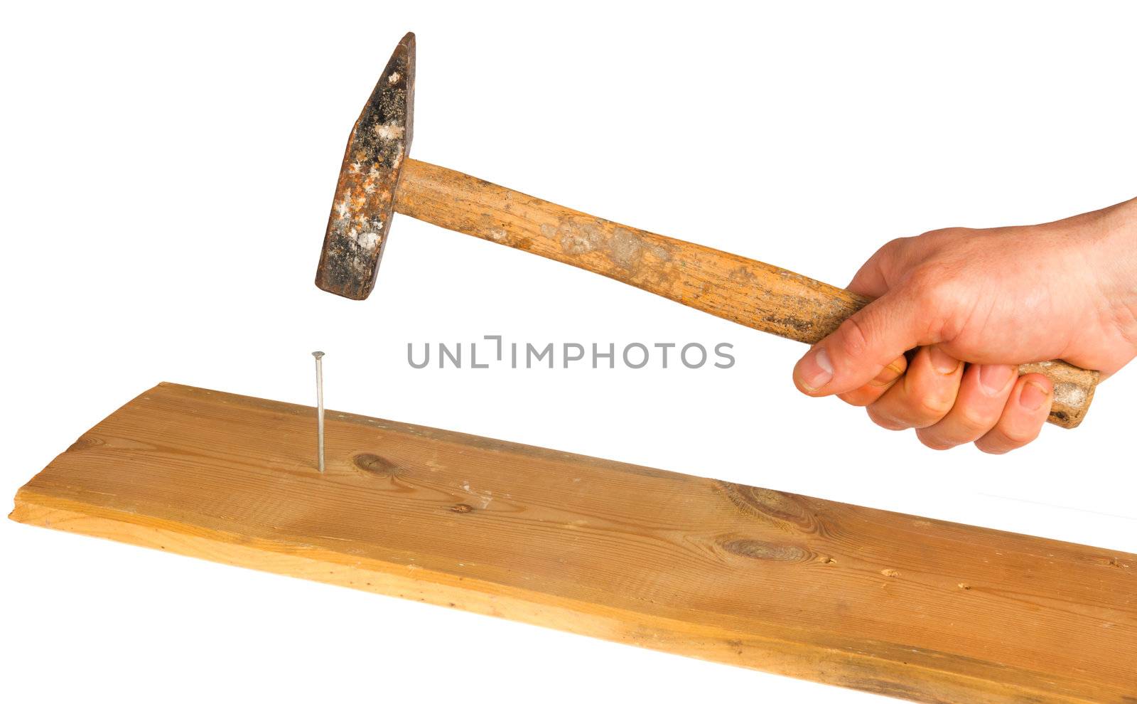 Hammer hits a nail, isolated on background