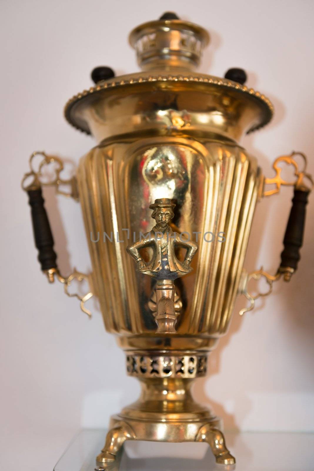 Traditional samovar with man figure valve and selective focus on the front