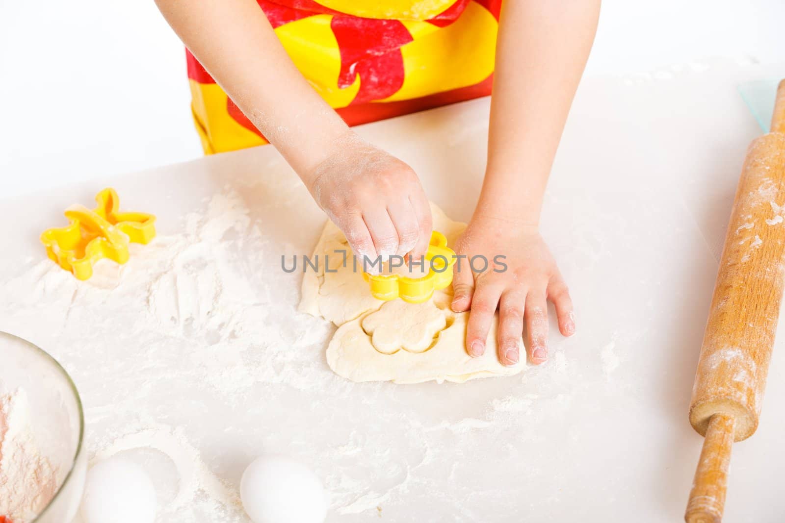 Beautiful hand boys making a cake, isolated on white background.