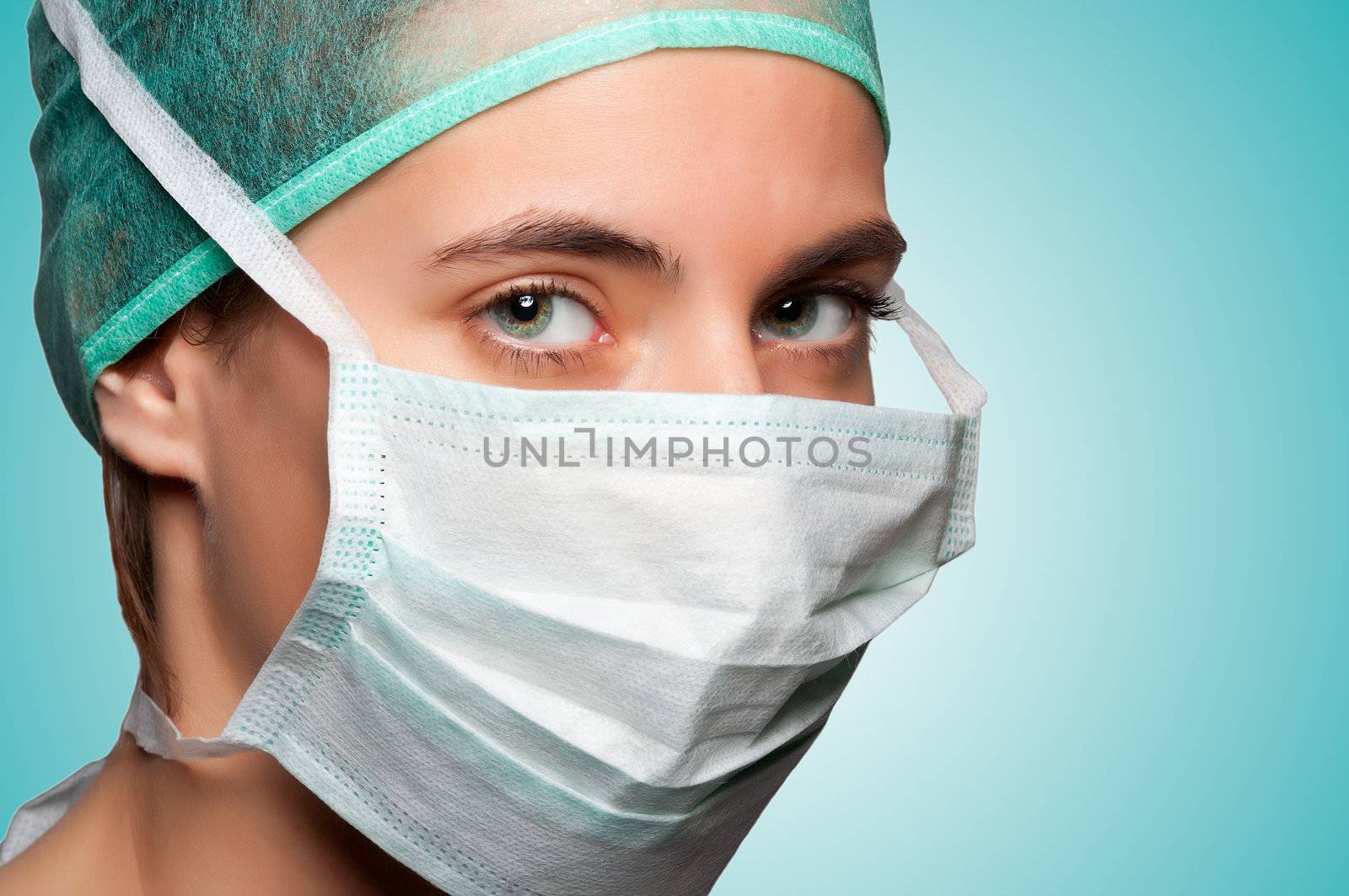 Closeup portrait of a female surgeon in a green background