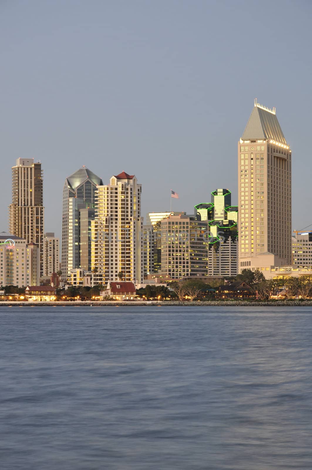 The last rays of sunlight reflect off of the waterfront towers in San Diego, California.