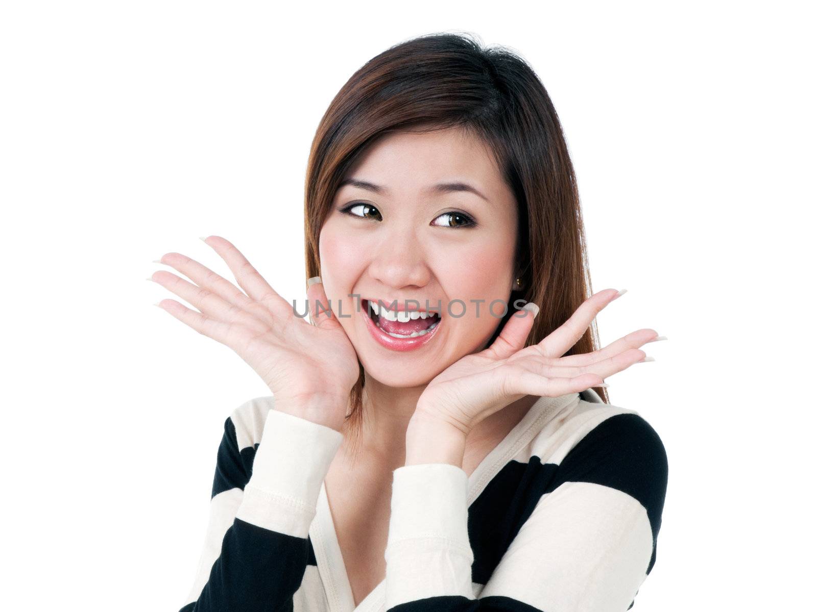 Portrait of an attractive young Asian woman looking surprised over white background.