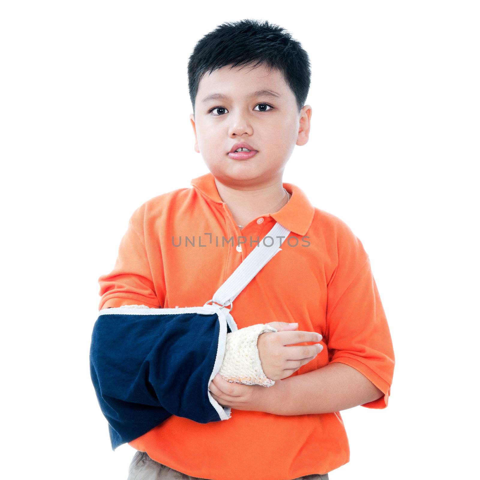 Portrait of a young Asian boy with broken arm in plaster cast, isolated on white background.