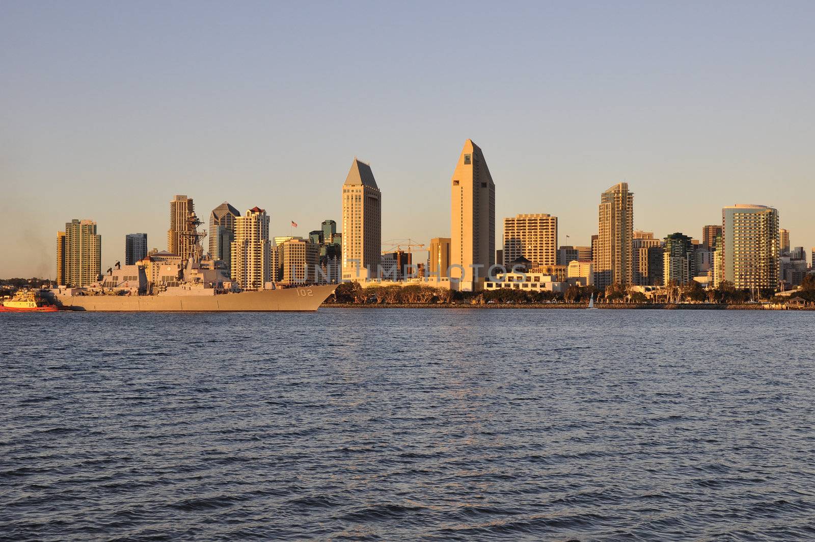 A U.S. Naval ship passes by the downtown San Diego skyline in Southern California.