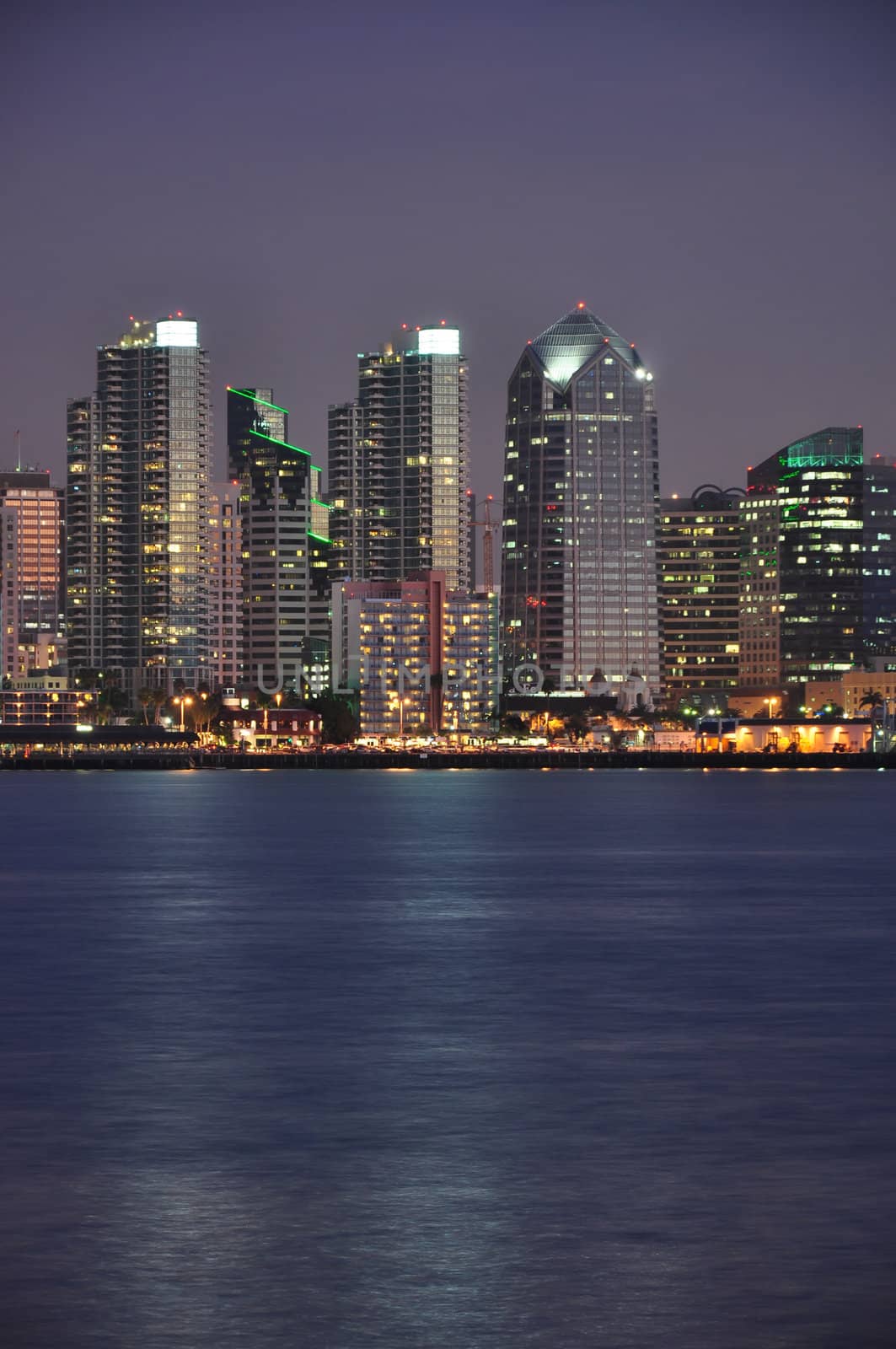 View of some tall office towers at night which line the waterfront in San Diego, California.