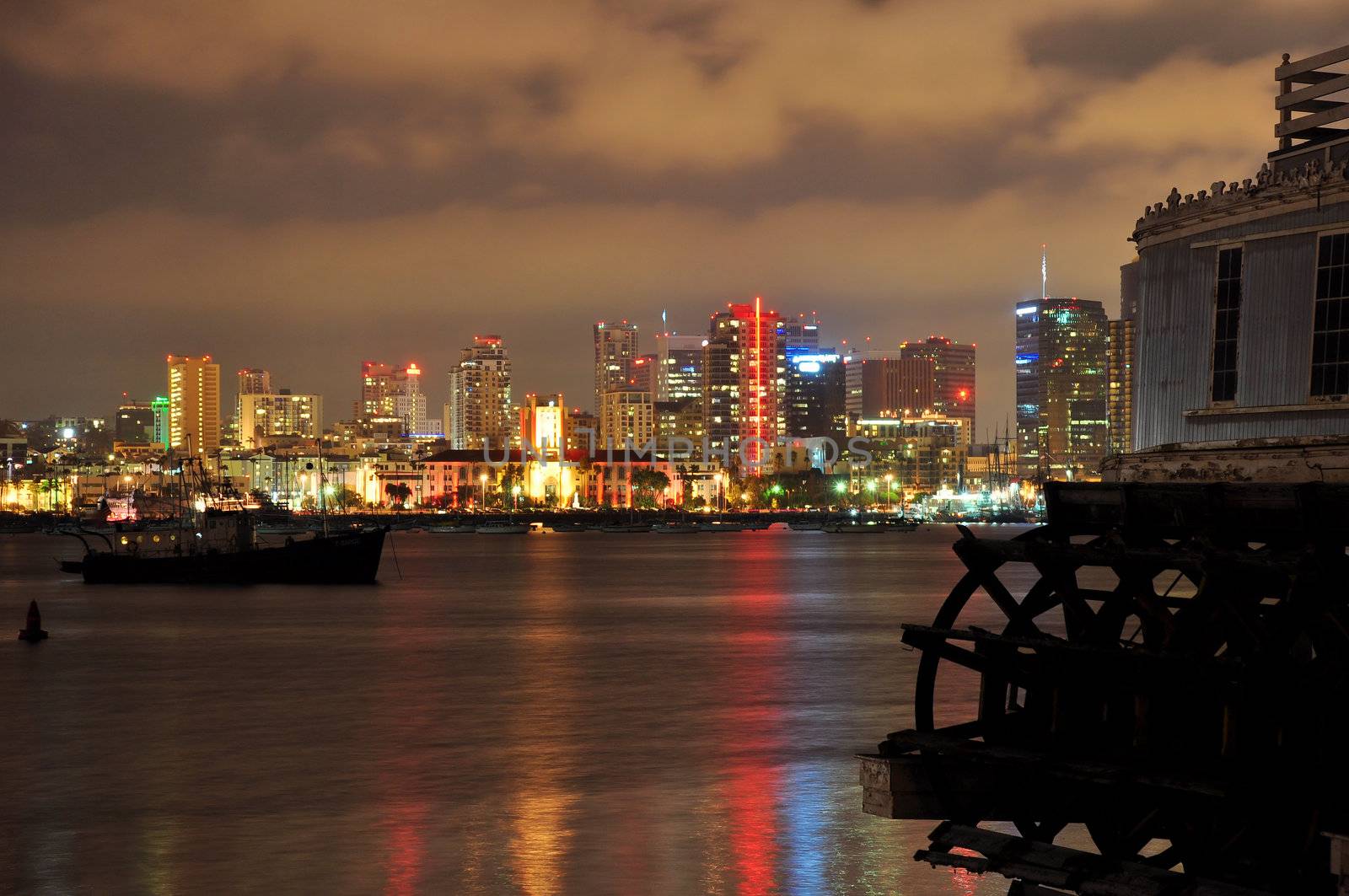 An old paddle wheel boat frames this view of the San Diego city skyline at night.