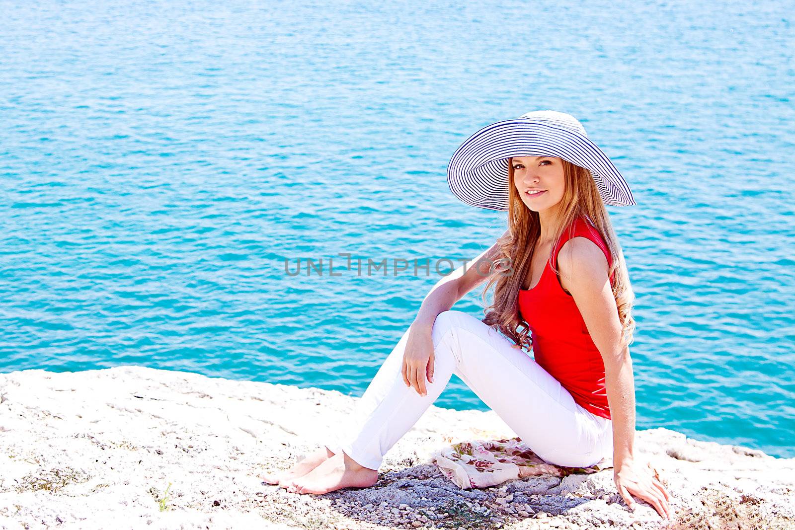 portrait of a beautiful young girl who rests on the coast