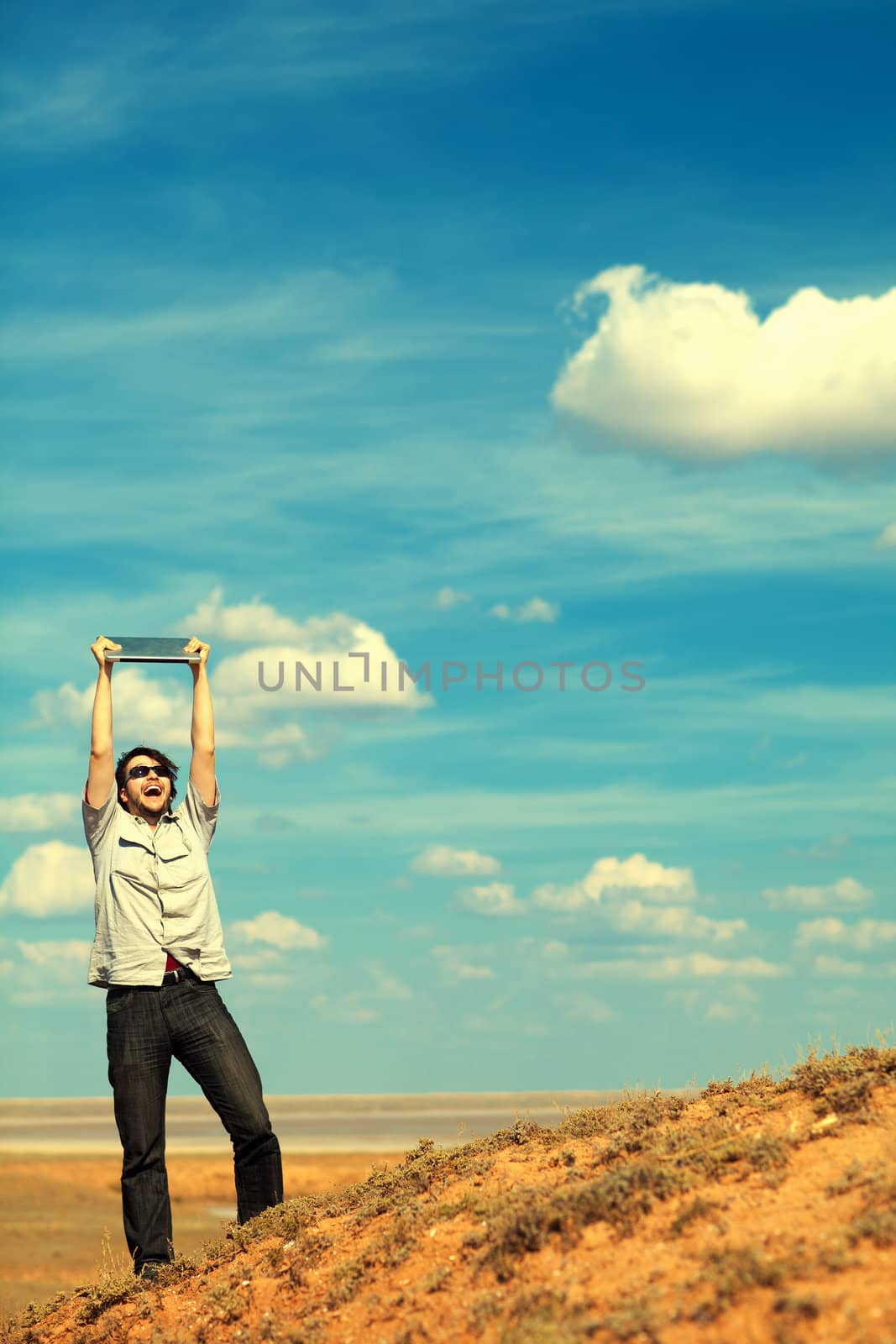 young man with laptop outdoors