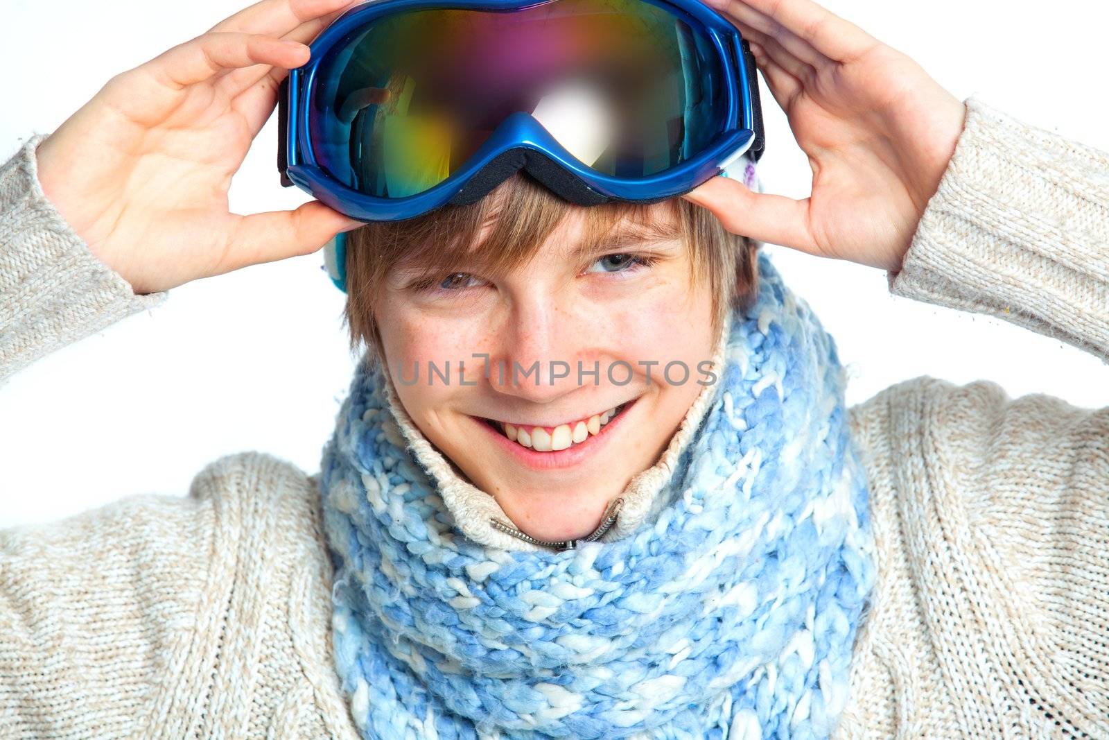 Clouse up portrait of a caucasian cute teenager in ski goggles and a scarf, isolated on white