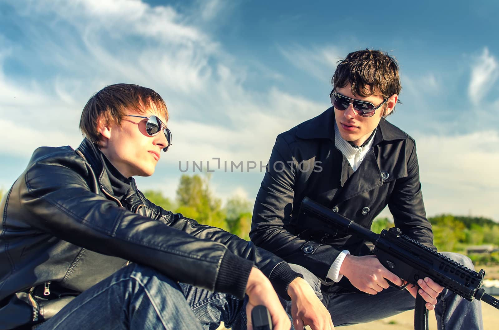 Portrait of two tough guys with guns