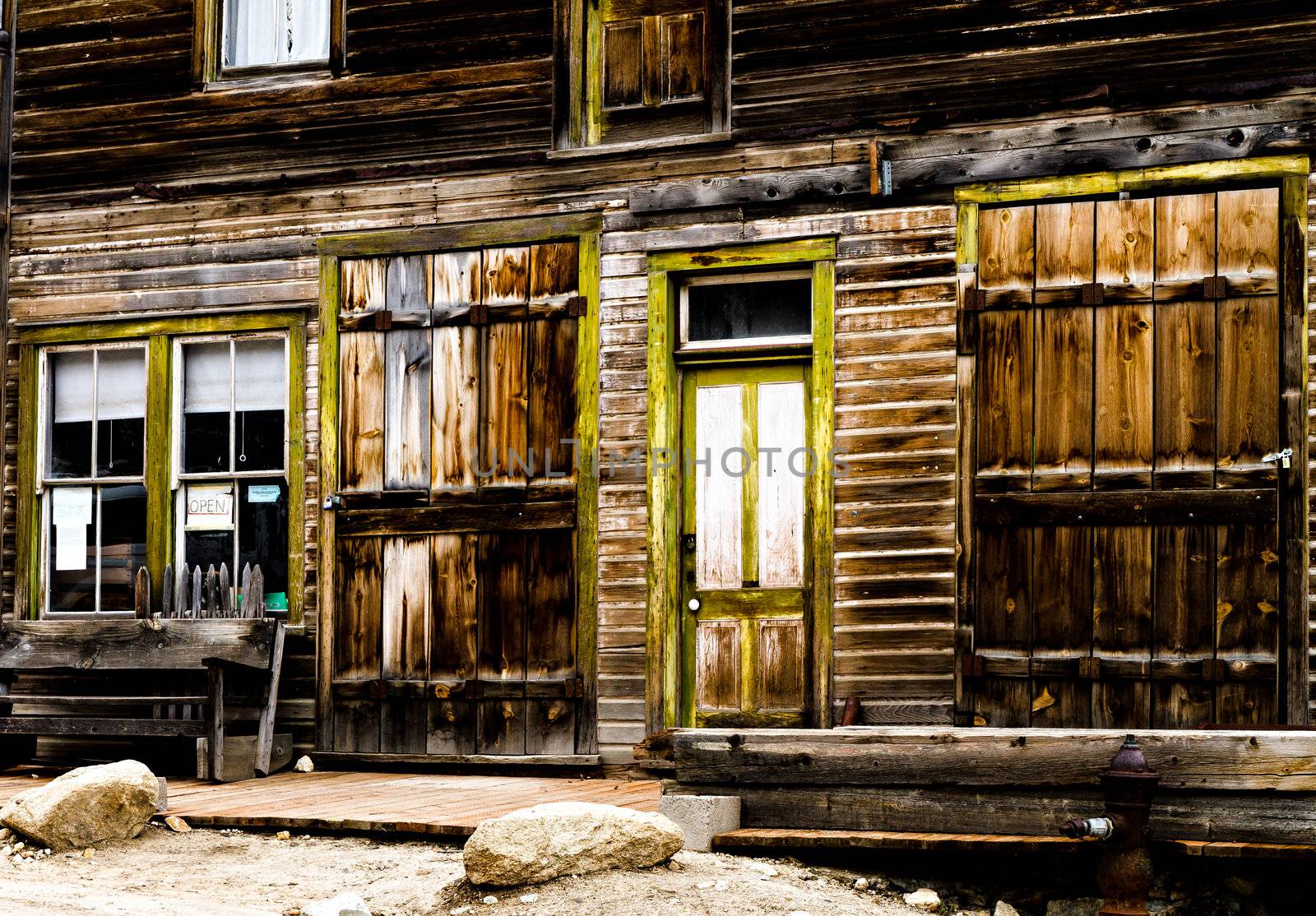 Wooden storefront of an old mining ghost town that is weathered.